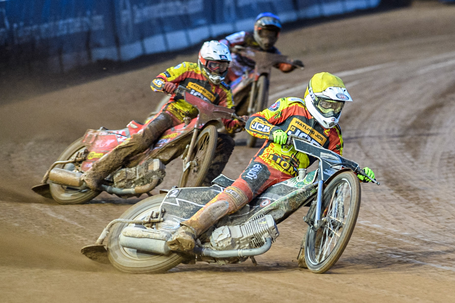 Richard Lawson of Leicester Lions in Yellow leading Max Fricke of Leicester Lions in White and Ben Cook of Belle Vue Aces in Blue during the Rowe Motor Oil Premiership match between Belle Vue Aces and Leicester Lions at the National Speedway Stadium, Manchester on Saturday 6th April 2024. (Photo: Ian Charles | MI News)