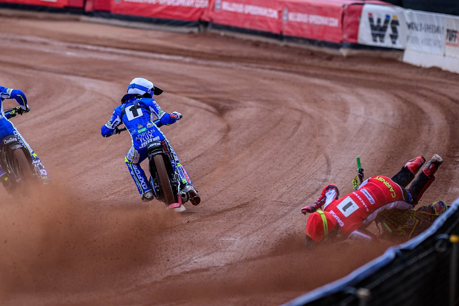 Belle Vue Colts' William Cairns falls whilst trying to pass Oxford Chargers' Jody Scott  in White and Oxford Chargers' Jacob Clouting  in Yellow during the WSRA National Development League match between Belle Vue Colts and Oxford Chargers at the National Speedway Stadium, Manchester on Sunday 1st June 2025. (Photo: Ian Charles | MI News)