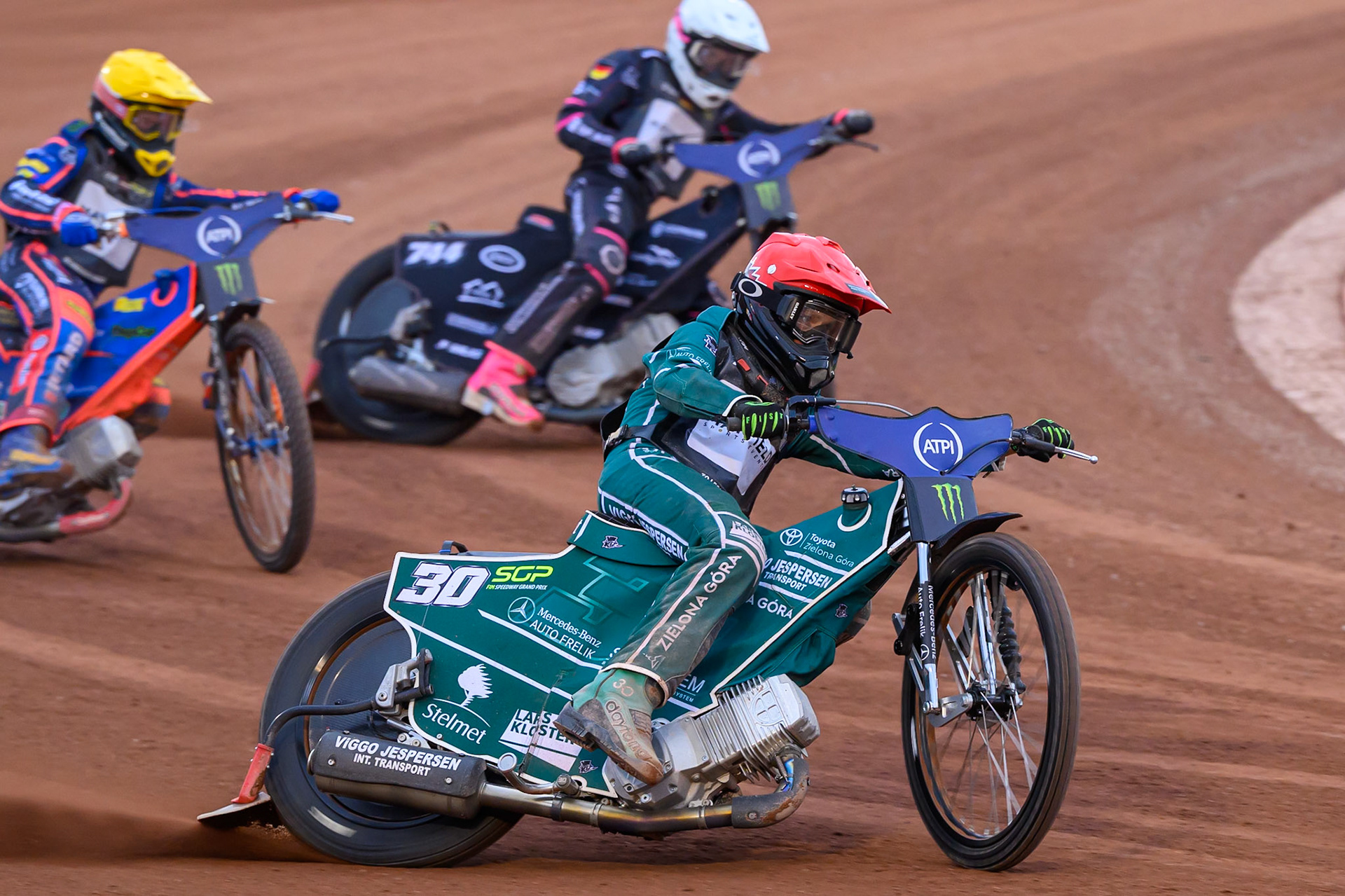Leon Madsen (30) of Denmark in Red leadingAndzejs Lebedevs (29) of Latvia in Yellow and Kai Huckenbeck (744) of Germany in White during the ATPI  FIM Speedway GP of Manchester at the National Speedway Stadium, Manchester on Friday 5th June 2026. (Photo: Ian Charles | MI News)