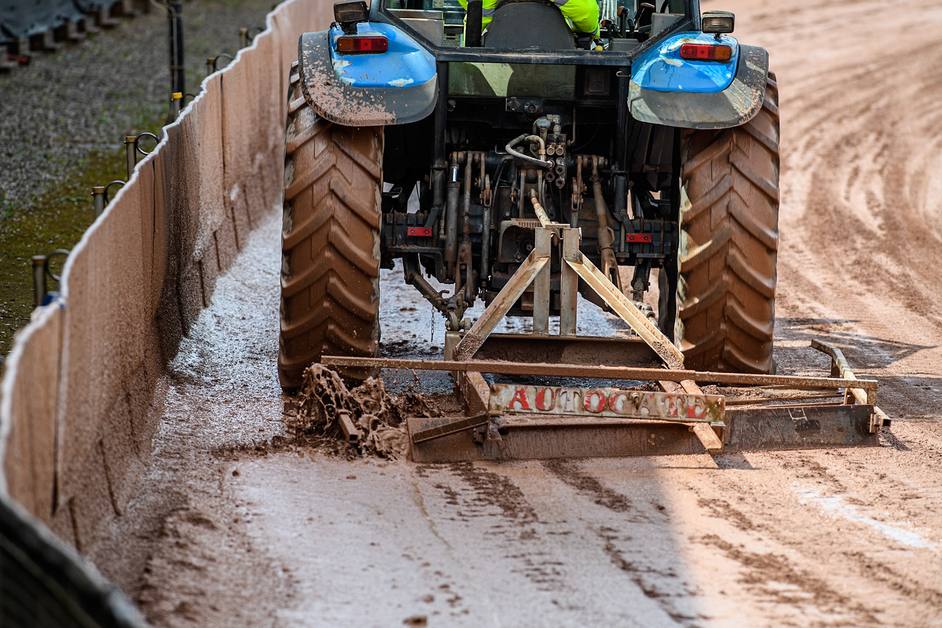 The tractor at Bele Vue tries to scrape off the loose slop on the track during the Rowe Motor Oil Premiership match between Belle Vue Aces and Sheffield Tigers at the National Speedway Stadium, Manchester on Monday 27th May 2024. (Photo: Ian Charles | MI News)