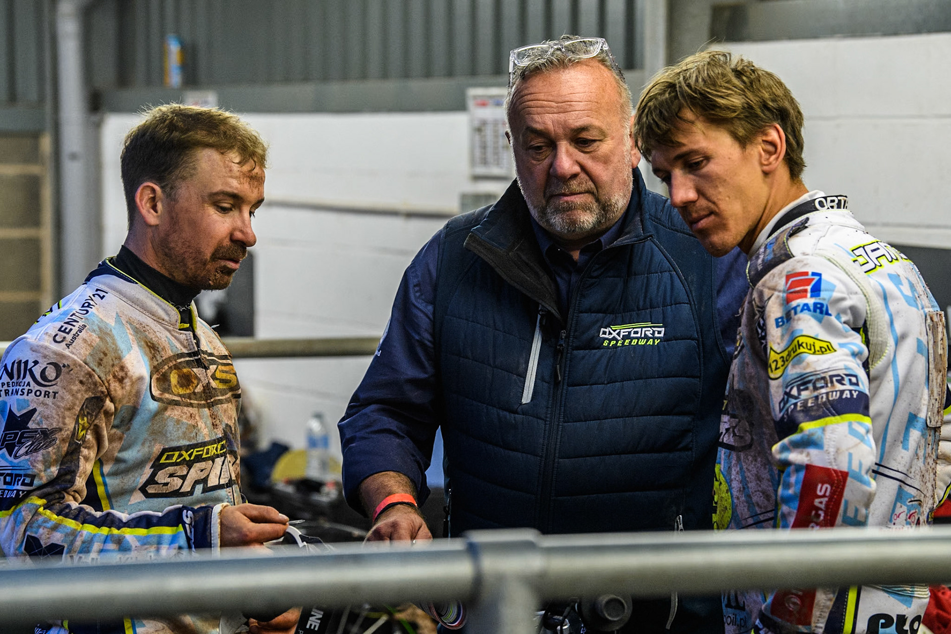 Oxford Spires' Rohan Tungate (Left) with Oxford Spires' Team Manager Peter Schroek (Centre) and Oxford Spires' Maciej Janowski (Right) during the Rowe Motor Oil Premiership match between Belle Vue Aces and Oxford Spires at the National Speedway Stadium, Manchester on Monday 13th May 2024. (Photo: Ian Charles | MI News)