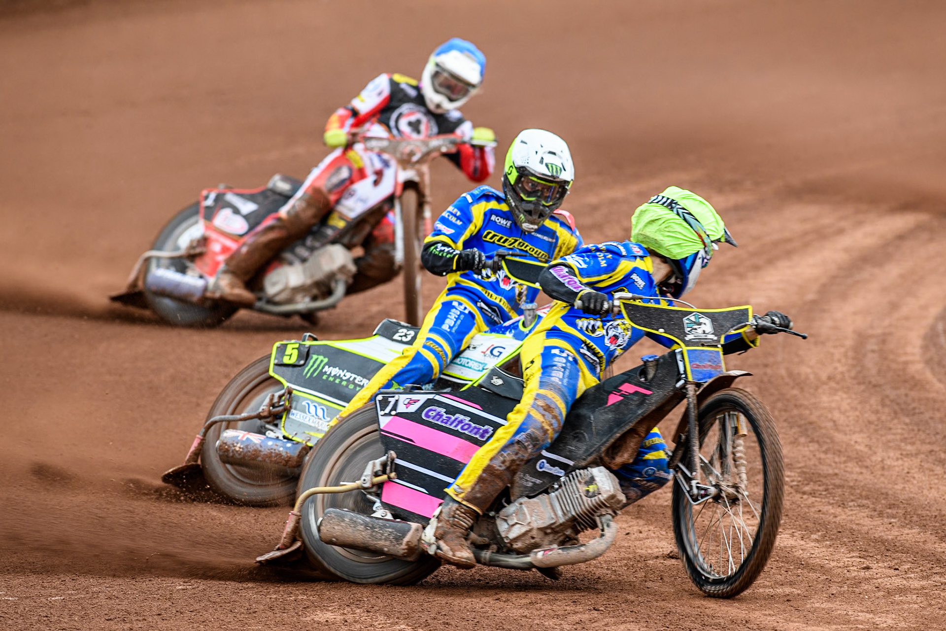 Leon Flint of Sheffield Tigers in Yellow looks for team mated Chris Holder of Sheffield Tigers in White ahead of Jake Mulford of Belle Vue Aces in Blue uring the Rowe Motor Oil Premiership match between Belle Vue Aces and Sheffield Tigers at the National Speedway Stadium, Manchester on Monday 5th May 2025. (Photo: Ian Charles | MI News)