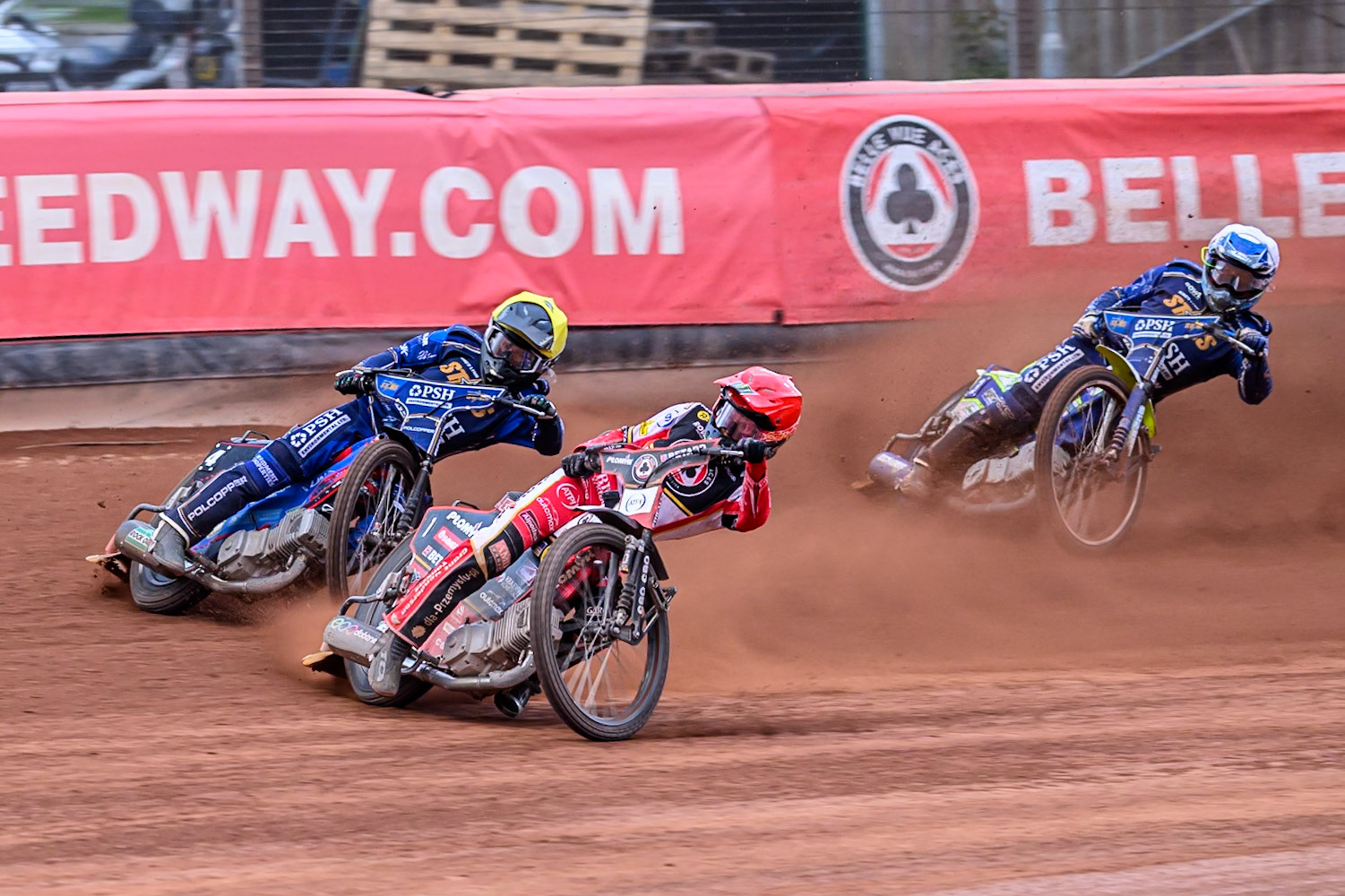 Belle Vue Aces' Dan Bewley in Red leading Kings Lynn Stars' Ben Cook in Yellow and Kings Lynn Stars' Chris Harris in White during the Rowe Motor Oil Premiership match between Belle Vue Aces and King's Lynn Stars at the National Speedway Stadium, Manchester on Monday 23rd June 2025. (Photo: Ian Charles | MI News)