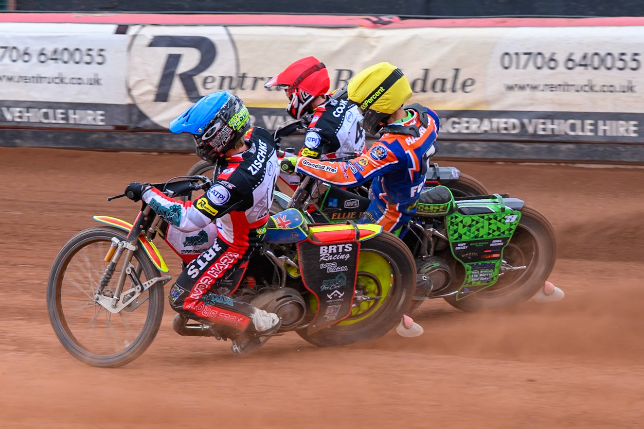 Tate Zischke of Belle Vue Aces in Blue rides inside Luke Harrison of Northampton Foxes in Yellow and Zach Cook of Belle Vue Aces in Red during the Rowe Motor Oil Premiership match between Belle Vue Aces and Northampton Foxes at the National Speedway Stadium, Manchester on Monday 4th May 2026. (Photo: Ian Charles | MI News)