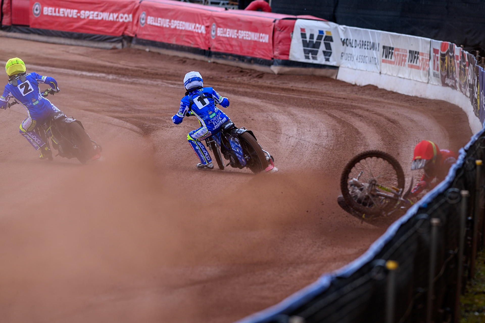 Belle Vue Colts' William Cairns falls whilst trying to pass Oxford Chargers' Jody Scott  in White and Oxford Chargers' Jacob Clouting  in Yellow during the WSRA National Development League match between Belle Vue Colts and Oxford Chargers at the National Speedway Stadium, Manchester on Sunday 1st June 2025. (Photo: Ian Charles | MI News)