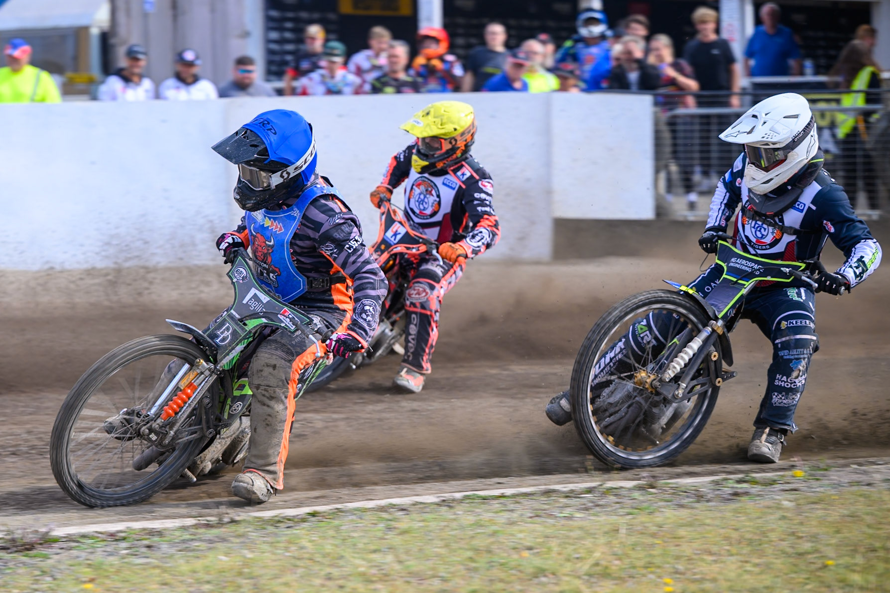 Jack Roberts of Buxton Bulls in Blue on the inside of Alex Spooner of Middlesborough Tigers in Yellow  with Nathan Ablitt of Middlesborough Tigers in White behind during the WSRA National Development League match  between Buxton Bulls and Middlesborough Tigers at Hi-Edge Speedway, Buxton on Sunday 16th August 2026. (Photo: Ian Charles | MI News)