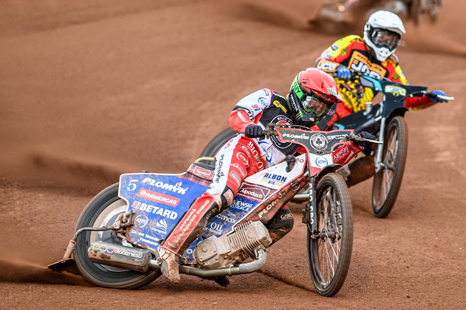 Belle Vue Aces' Dan Bewley in Red leading Leicester Lions' Ryan Douglas in White during the Rowe Motor Oil Premiership match between Belle Vue Aces and Leicester Lions at the National Speedway Stadium, Manchester on Monday 24th June 2024. (Photo: Ian Charles | MI News)
