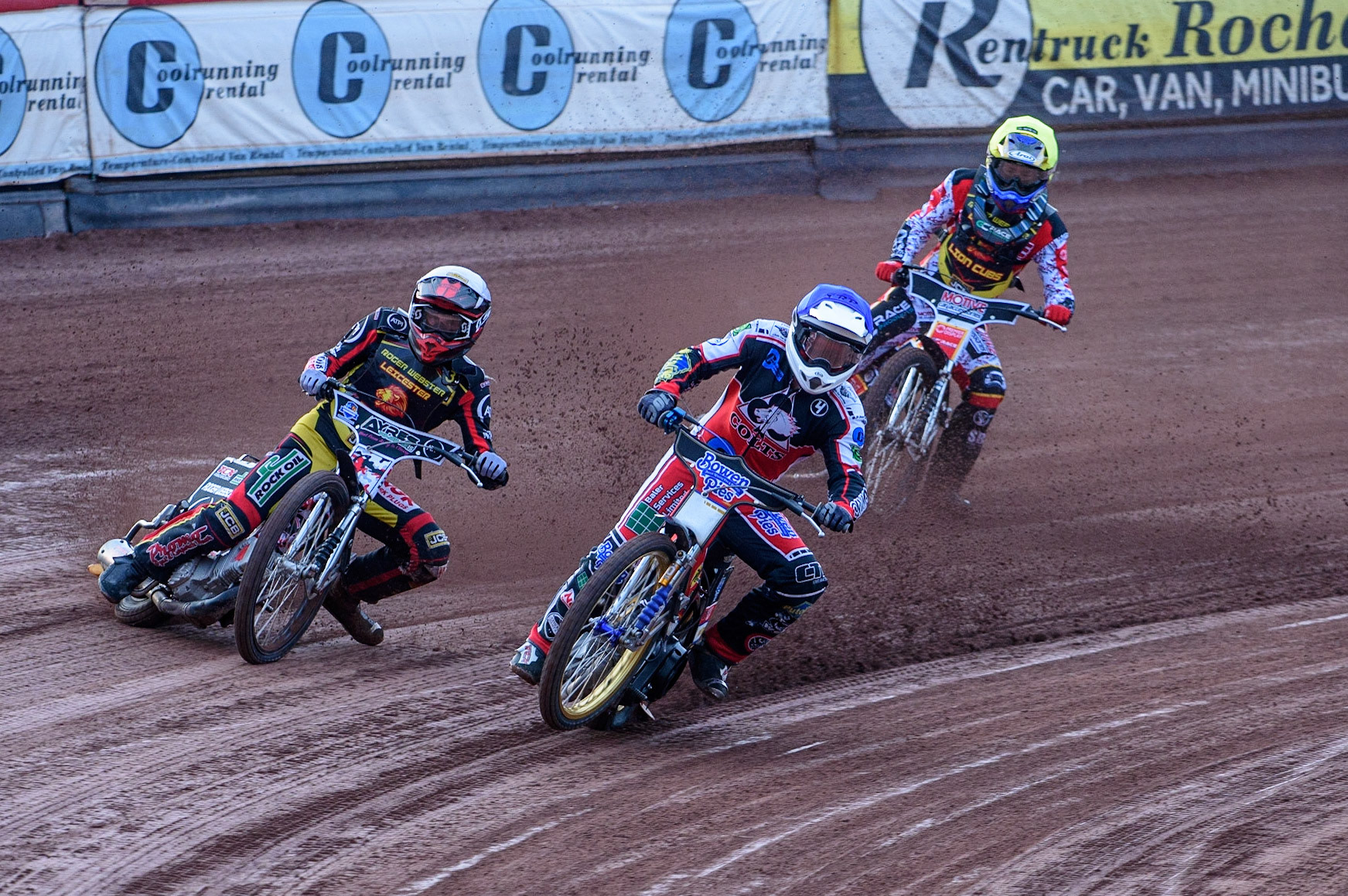 MANCHESTER, UK. JULY 29TH  Paul Bowen  (Blue) picks up some drive causing him to fall as he leads Joe Lawlor  (White) and Tom Spencer   (Yellow)  during the National Development League match between Belle Vue Colts and Leicester Lion Cubs at the National Speedway Stadium, Manchester on Thursday 29th July 2021. (Credit: Ian Charles | MI News)