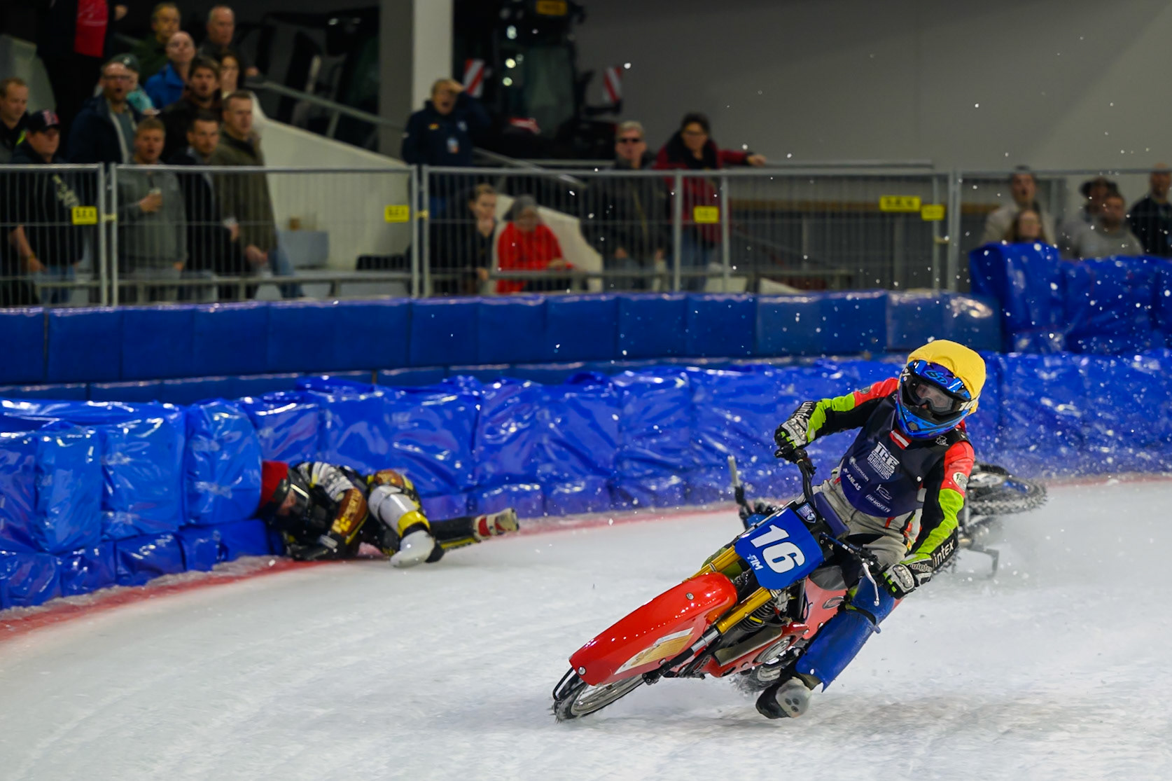 Heikki Huusko (67) of Finland  collides with Wild Card Harald Simon (16) of Austria in Yellow in the first turn during the FIM Ice Speedway Gladiators World Championship Final 3 at Ice Rink Thialf, Heerenveen on Saturday 11th April 2026. (Photo: Ian Charles | MI News)