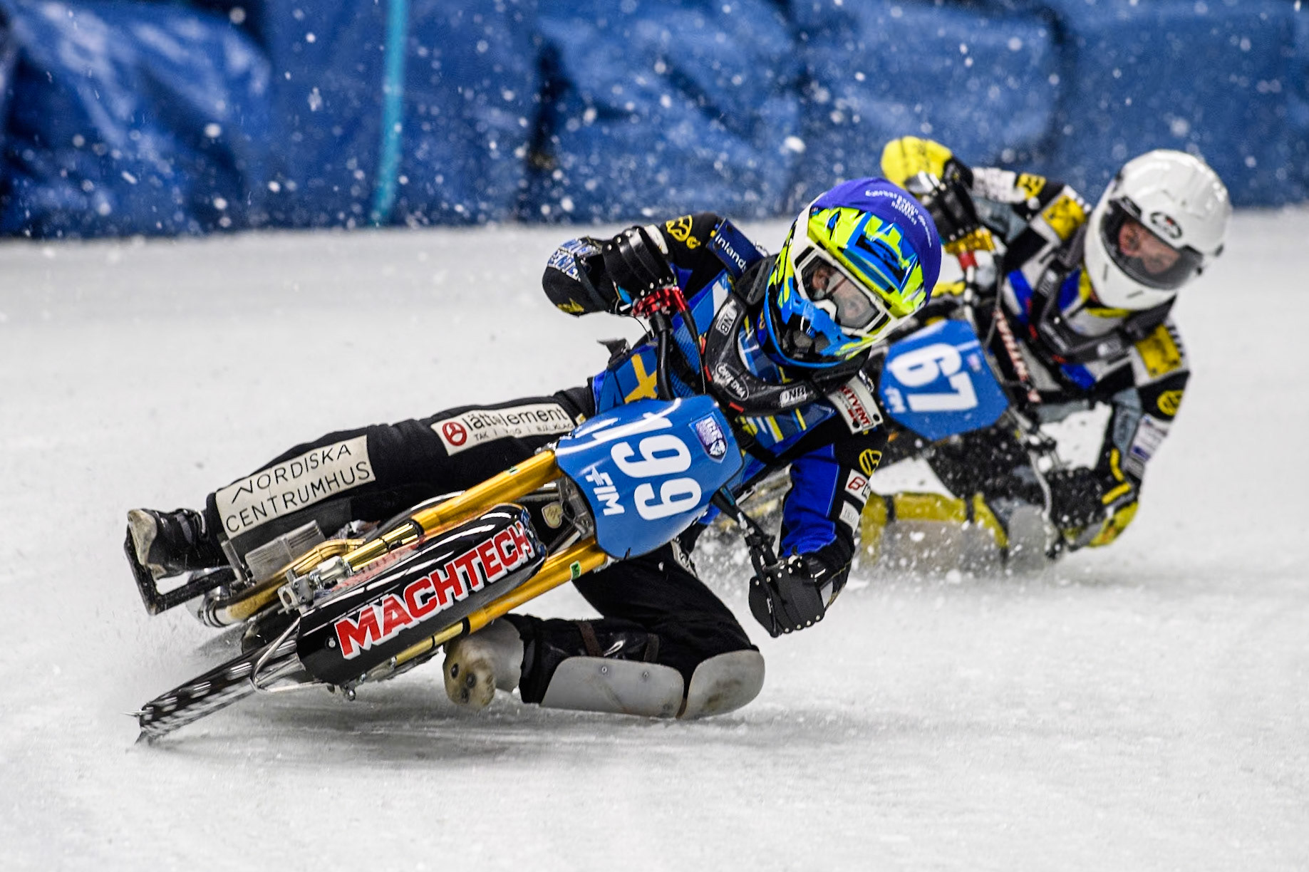 Sweden's Martin Haarahiltunen (199) (Blue) leads  Finland's Heikki Huusko (67) (White) during the FIM Ice Speedway Gladiators World Championship Final 1 at the Max-Aicher-Arena, Inzell on Saturday 23 March 2024. (Photo: Ian Charles | MI News)