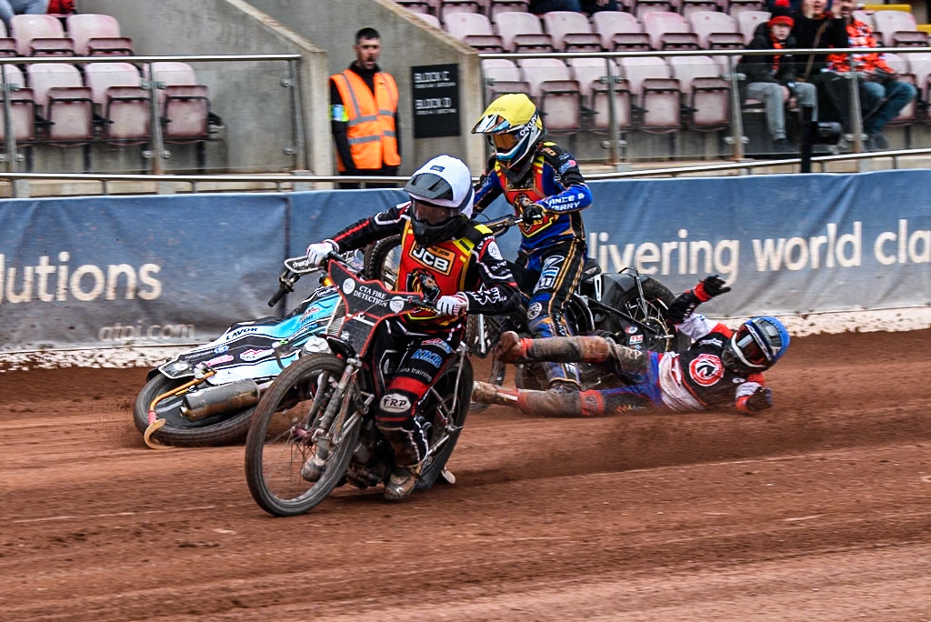 Belle Vue Colts' Harry Fletcher in Blue rears and falls between Leicester Lion Cubs' Guest Rider Ben Morley in White and Leicester Lion Cubs' Eli Meadows in Yellow during the WSRA National Development League match between Belle Vue Colts and Leicester Lion Cubs at the National Speedway Stadium, Manchester on Friday 18th April 2025. (Photo: Ian Charles | MI News)