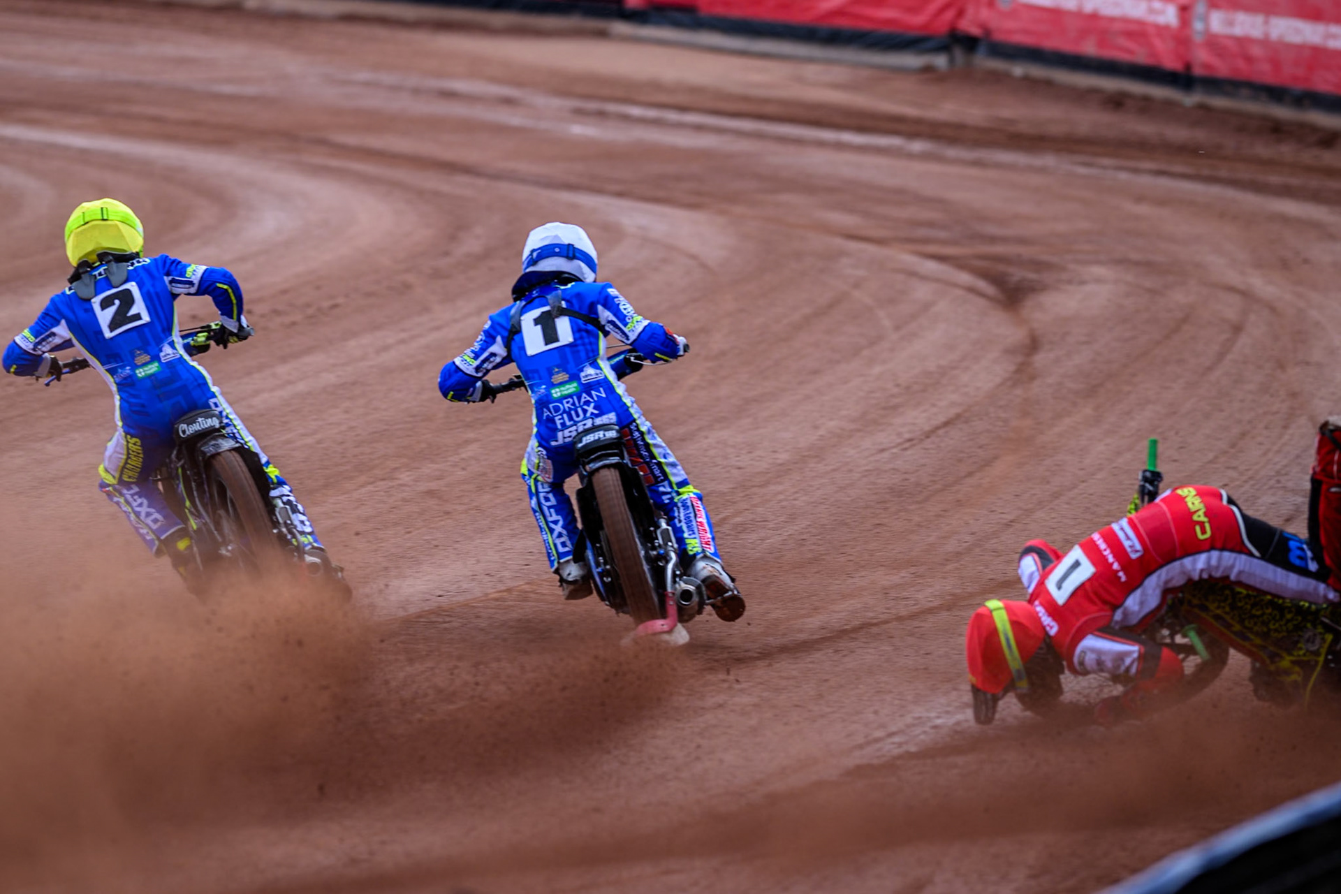 Belle Vue Colts' William Cairns falls whilst trying to pass Oxford Chargers' Jody Scott  in White and Oxford Chargers' Jacob Clouting  in Yellow during the WSRA National Development League match between Belle Vue Colts and Oxford Chargers at the National Speedway Stadium, Manchester on Sunday 1st June 2025. (Photo: Ian Charles | MI News)
