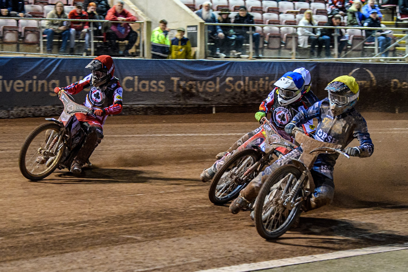 Ashton Boughen of Kings Lynn Stars in Yellow rides inside Jake Mulford of Belle Vue Aces in Blue, Norick Blödorn of Belle Vue Aces in Red and Richard Lawson of Kings Lynn Stars in White during the Rowe Motor Oil Premiership match between Belle Vue Aces and King's Lynn Stars at the National Speedway Stadium, Manchester on Monday 5th April 2025. (Photo: Ian Charles | MI News)