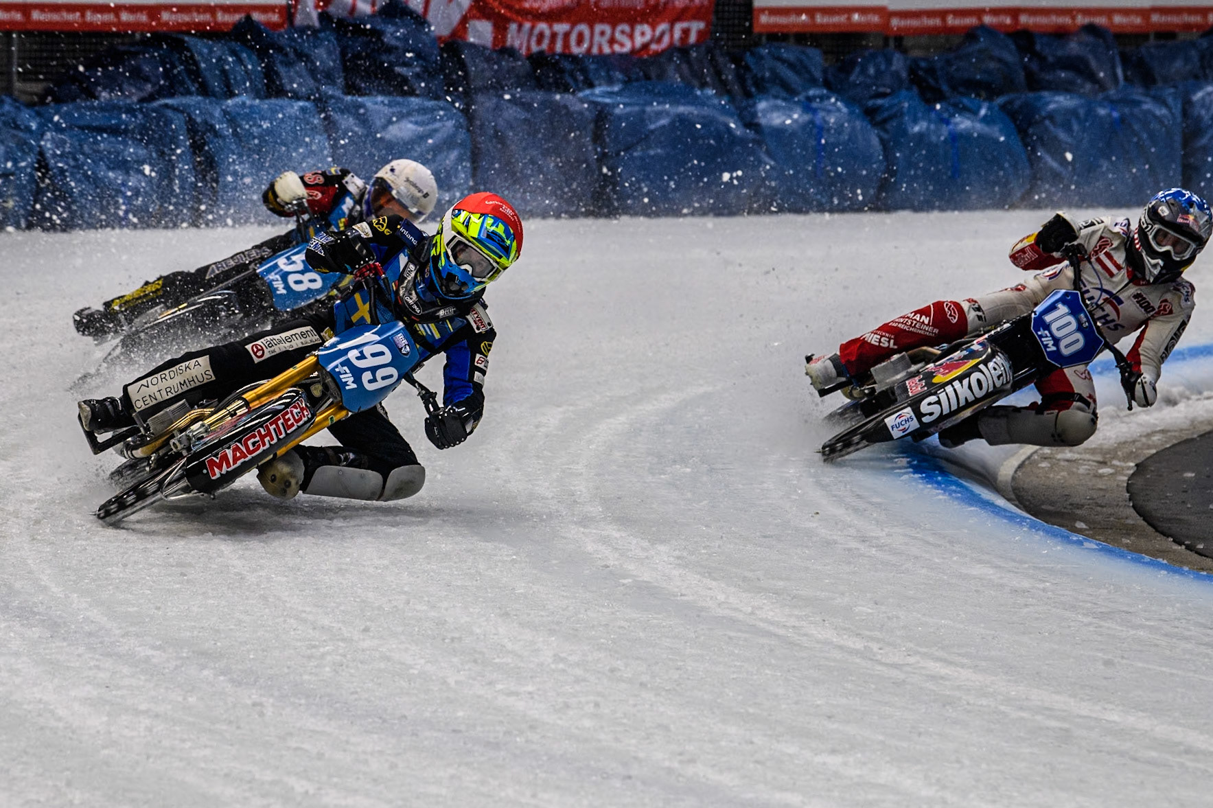 Sweden's Martin Haarahiltunen (199)  (Red) outside Austria's Franz Zorn (100) (Blue) with Sweden's Stefan Svensson (58) behind during the FIM Ice Speedway Gladiators World Championship Final 2 at the Max-Aicher-Arena, Inzell on Sunday 24 March 2024. (Photo: Ian Charles | MI News)