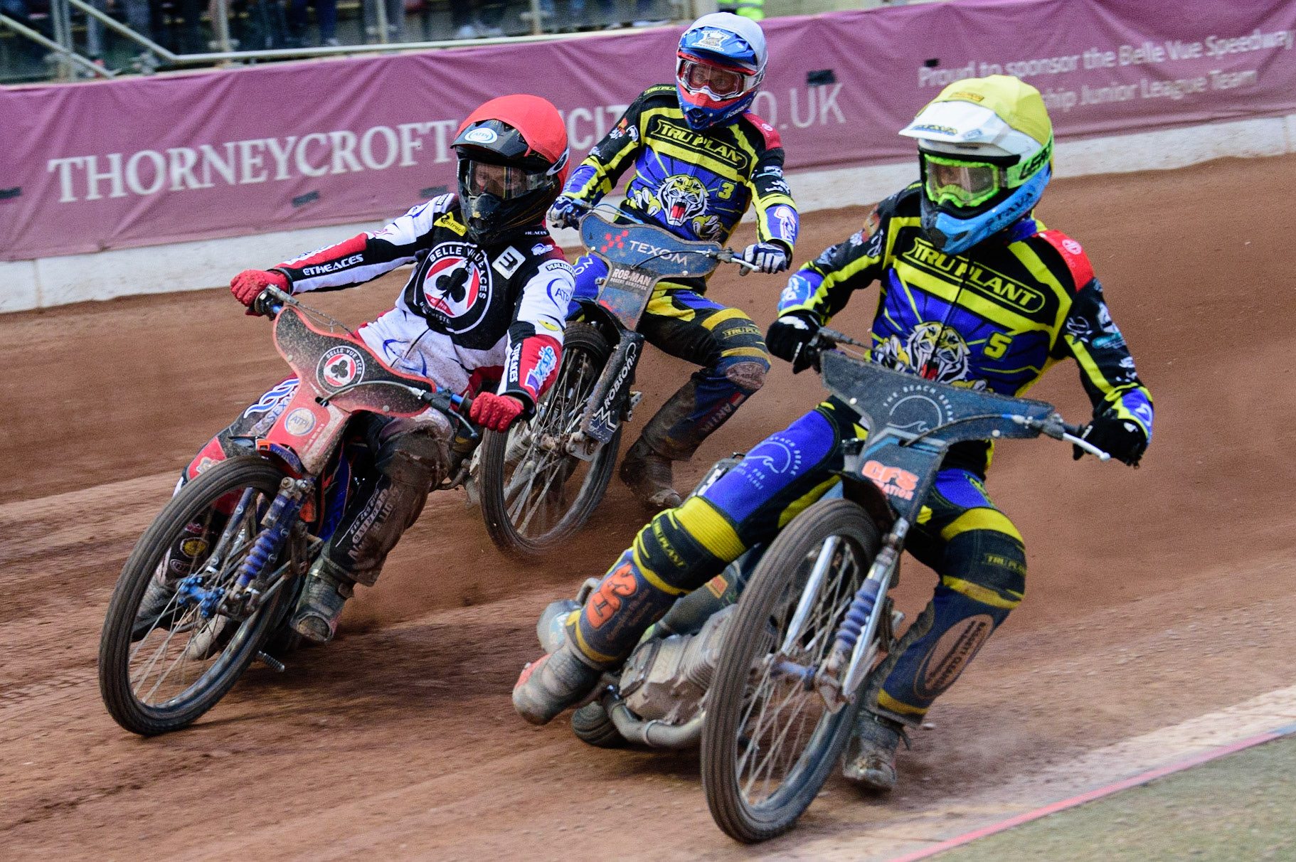 MANCHESTER, UK. JUL 5TH  Adam Ellis  (Yellow) inside Brady Kurtz  (Red) with Tobiasz Musielak  behind  during the SGB Premiership match between Belle Vue Aces and Sheffield Tigers at the National Speedway Stadium, Manchester on Tuesday 5th July 2022. (Credit: Ian Charles | MI News)