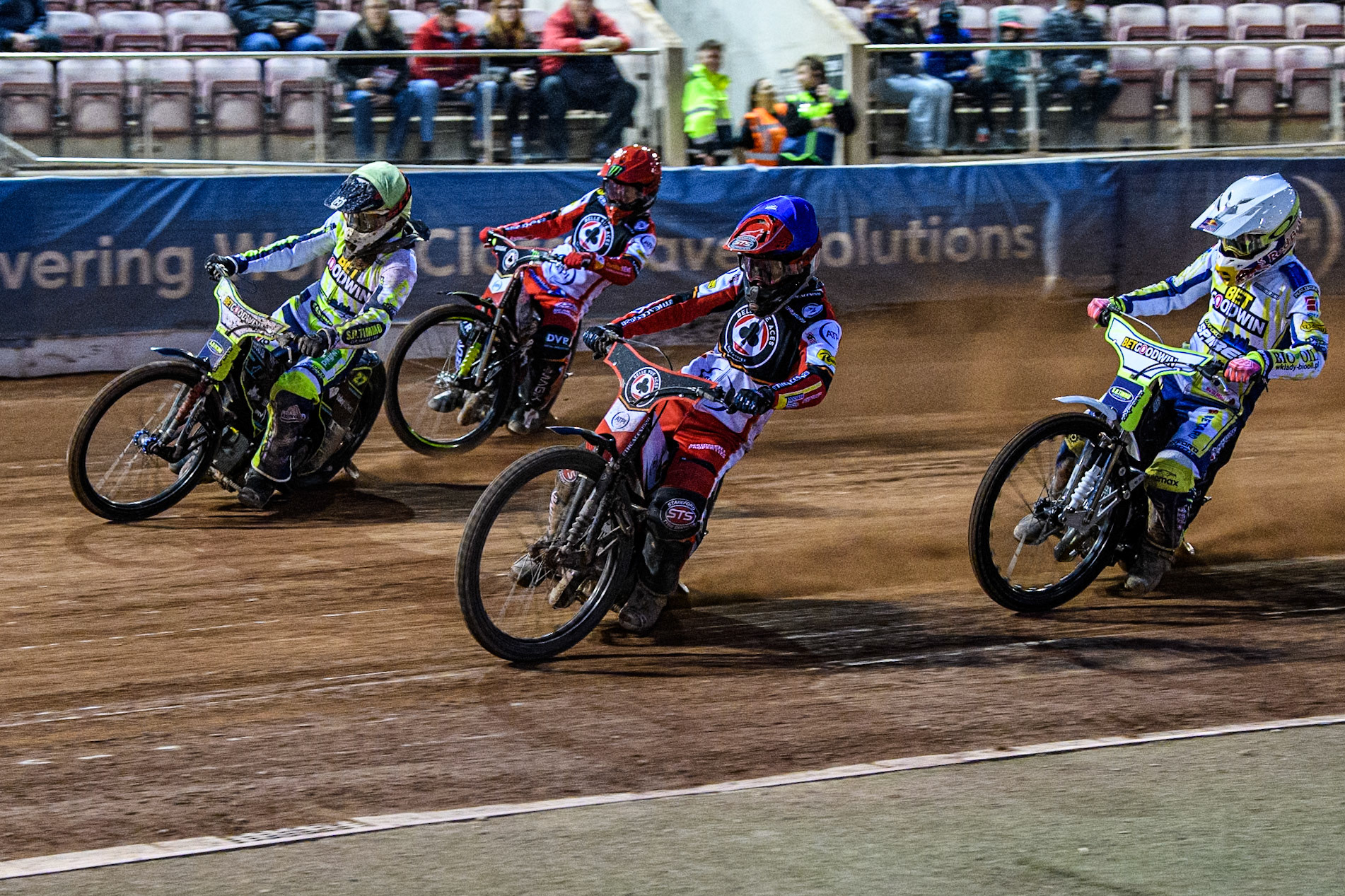 Belle Vue Aces' Zack Cook in Blue rides inside Oxford Spires' Francis Gusts in Yellow with Oxford Spires' Maciej Janowski in White and Belle Vue Aces' Jaimon Lidsey in Red behind during the Rowe Motor Oil Premiership match between Belle Vue Aces and Oxford Spires at the National Speedway Stadium, Manchester on Monday 14th April 2025. (Photo: Ian Charles | MI News)