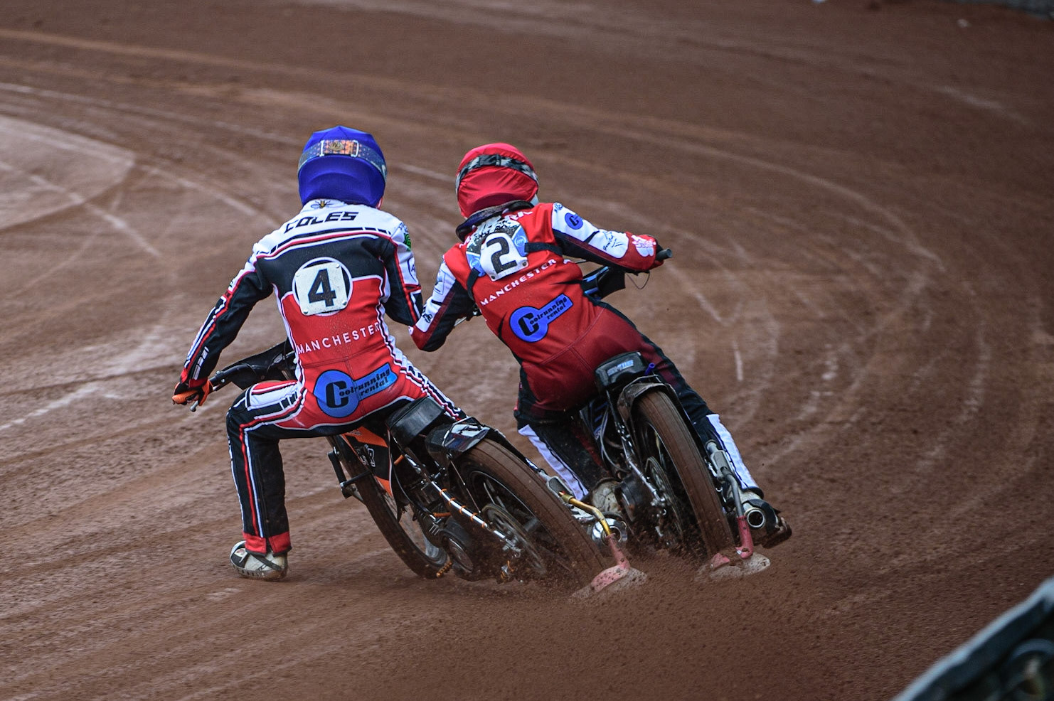 MANCHESTER, UK. APR 15TH Sam McGurk  (Red) passes his team mate Connor Coles  (Blue) during the National Development League match between Belle Vue Colts and Plymouth Centurions at the National Speedway Stadium, Manchester on Friday 15th April 2022. (Credit: Ian Charles | MI News)