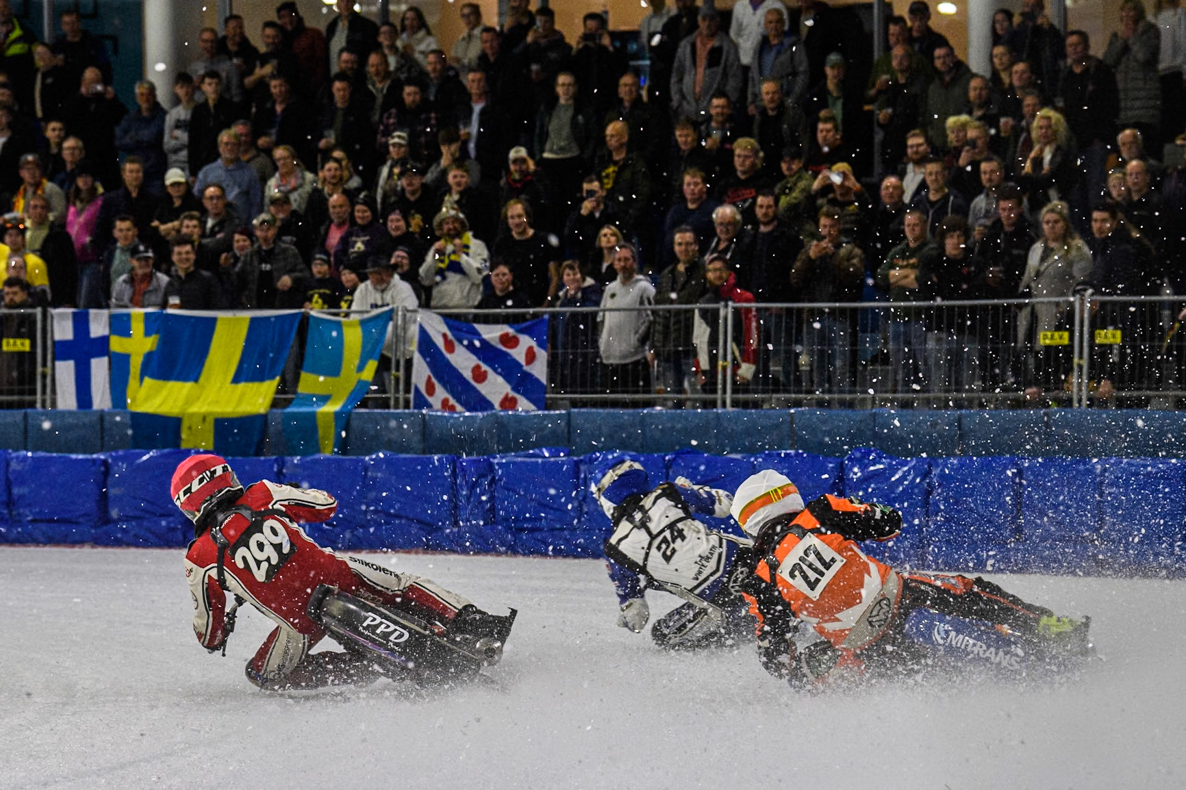 Lukas Hutla (212) of the Czech Republic in White chases Max Koivula (24) of Finland in Blue and Martin Posch (299) of Austria in Red during the FIM Ice Speedway Gladiators World Championship, Final 3 at the Ice Stadium, Thialf, Heerenveen on Saturday 5th April 2025. (Photo: Ian Charles | MI News)