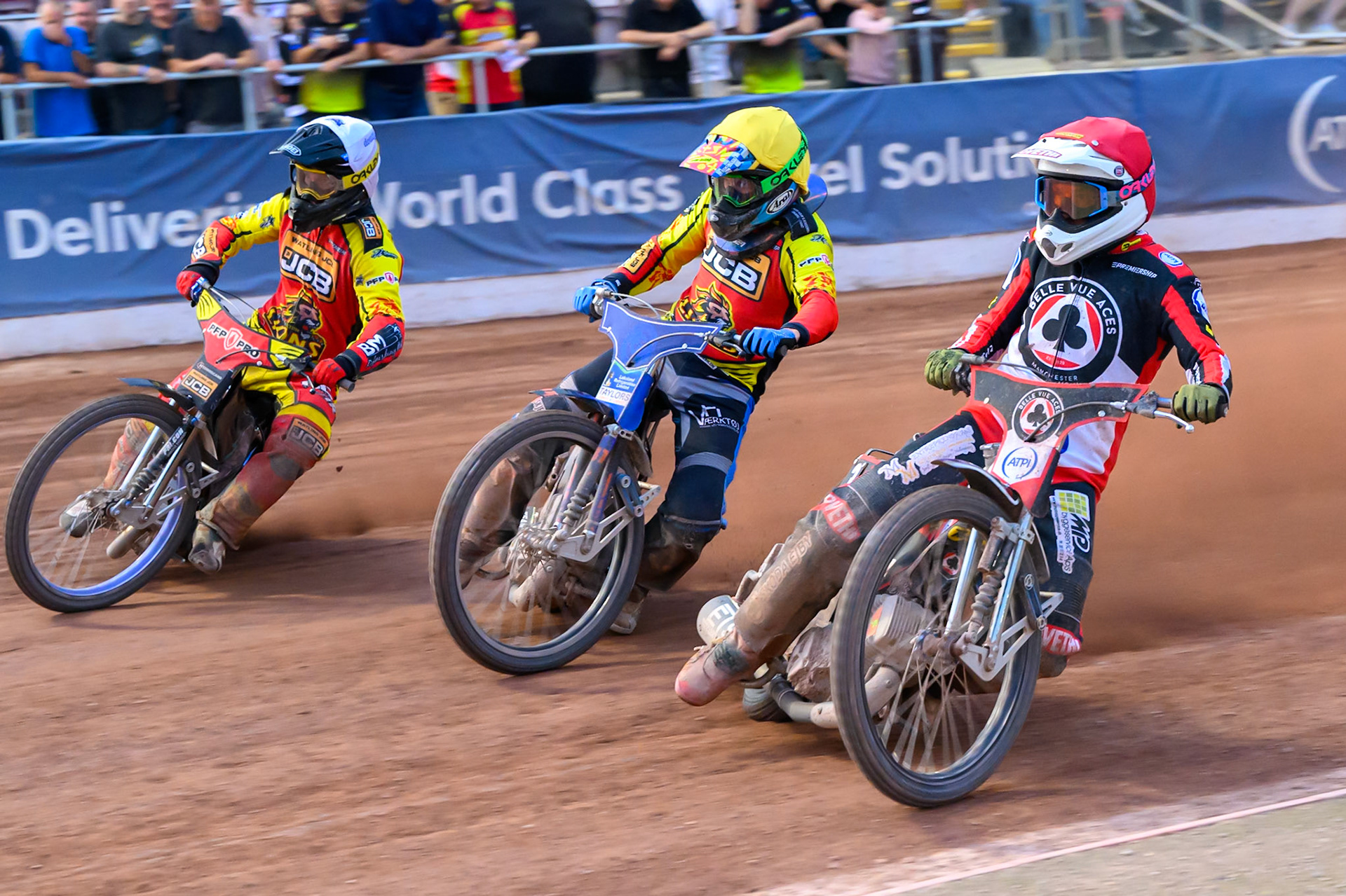 Peter Kildemand of Belle Vue Aces in Red on the inside of Jonas Jeppesen Guest rider for Leicester Lions in Yellow  and Ryan Douglas of Leicester Lions in White during the Rowe Motor Oil Premiership match between Belle Vue Aces and Leicester Lions at the National Speedway Stadium, Manchester on Monday 3rd August 2026. (Photo: Ian Charles | MI News)
