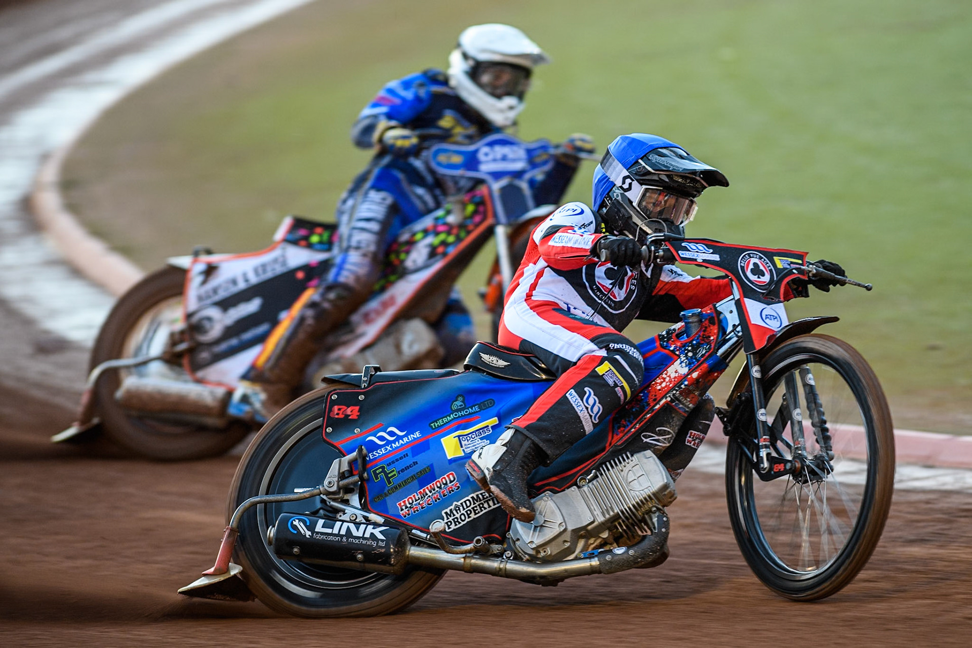 Belle Vue Aces' Ben Cook  in Blue leading Kings Lynn Stars' Niels-Kristian Iversen  in White during the Rowe Motor Oil Premiership match between Belle Vue Aces and King's Lynn Stars at the National Speedway Stadium, Manchester on Monday 12th August 2024. (Photo: Ian Charles | MI News)