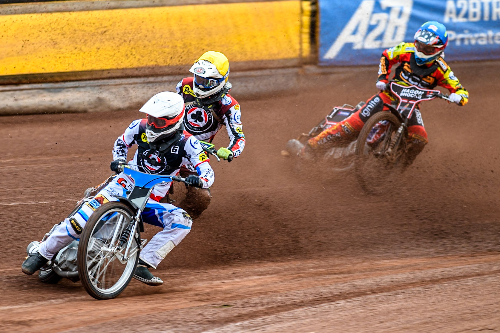 Belle Vue Aces' Antti Vuolas in White and team mate Jake Mulford in Yellow leading Leicester Lions' Sam Hagon in Blue during the Rowe Motor Oil Premiership match between Leicester Lions and Belle Vue Aces at the Pidcock Motorcycles Arena, Leicester on Thursday 25th July 2024. (Photo: Ian Charles | MI News)