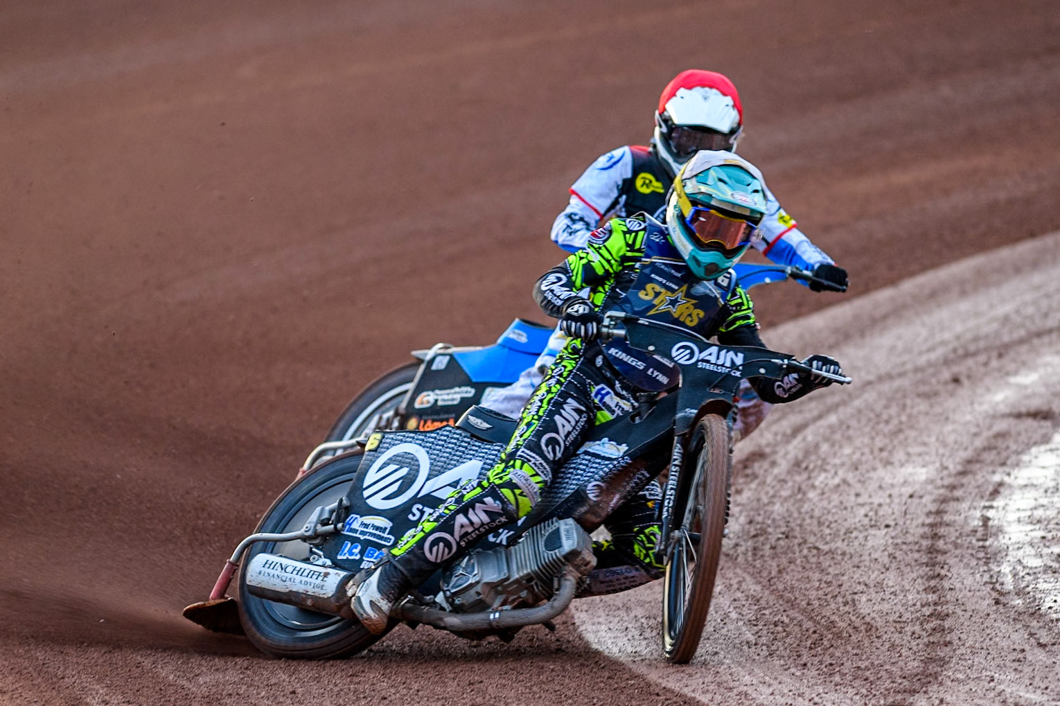 Kings Lynn Stars' Lewis Kerr  in White leading Belle Vue Aces' Antti Vuolas  in Red during the Rowe Motor Oil Premiership match between Belle Vue Aces and King's Lynn Stars at the National Speedway Stadium, Manchester on Monday 12th August 2024. (Photo: Ian Charles | MI News)