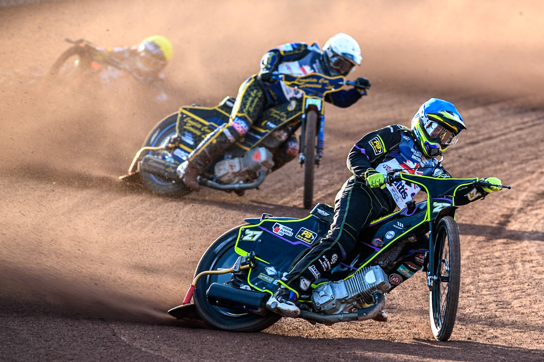Tom Brennan in Blue leading Kyle Howarth in White as Jordan Jenkins slides off behind during the Attis Insurance Sports Division British Speedway Championship Final at the National Speedway Stadium, Manchester on Saturday 8th June 2024. (Photo: Ian Charles | MI News)