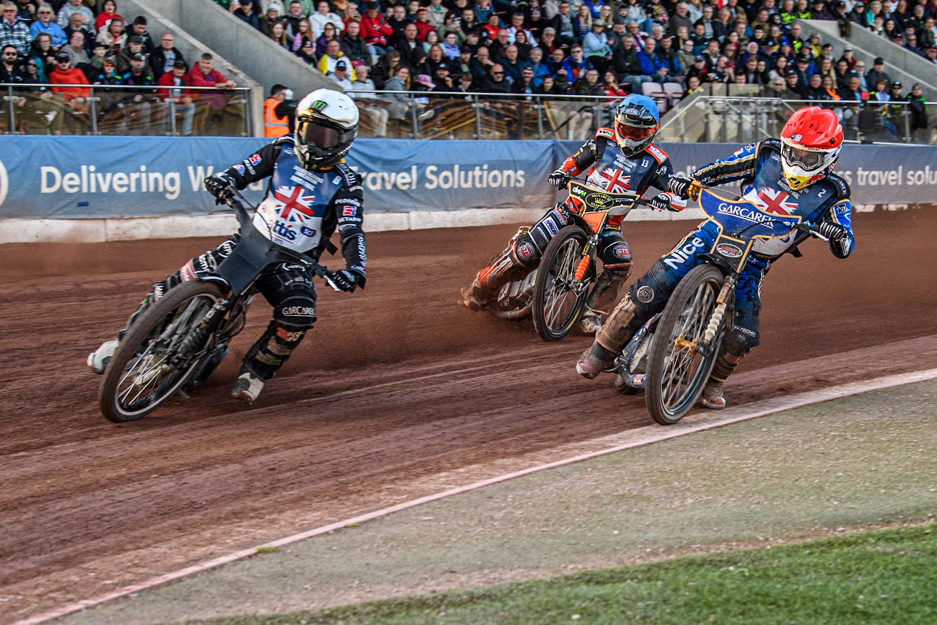 Robert Lambert in Red rides inside Tai Woffinden in White with Jordan Jenkins in Blue behind during the Attis Insurance Sports Division British Speedway Championship Final at the National Speedway Stadium, Manchester on Saturday 8th June 2024. (Photo: Ian Charles | MI News)