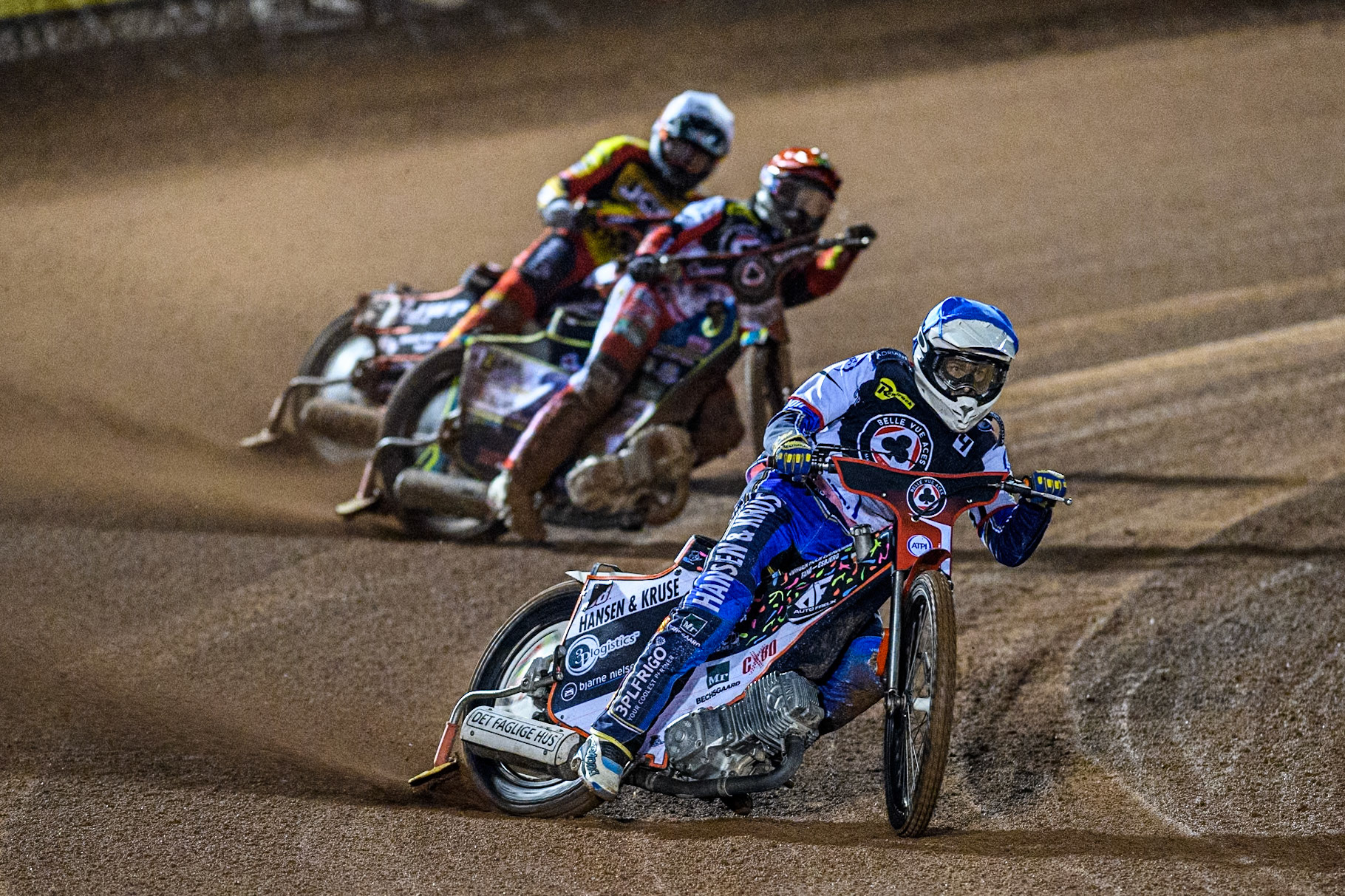 Belle Vue Aces' Guest Rider Niels. K. Iversen  in Blue leading Leicester Lions' Sam Masters  in White and Belle Vue Aces' Jaimon Lidsey  in Red during the Rowe Motor Oil Premiership Grand Final 1st Leg between Belle Vue Aces and Leicester Lions at the National Speedway Stadium, Manchester on Monday 23rd September 2024. (Photo: Ian Charles | MI News)