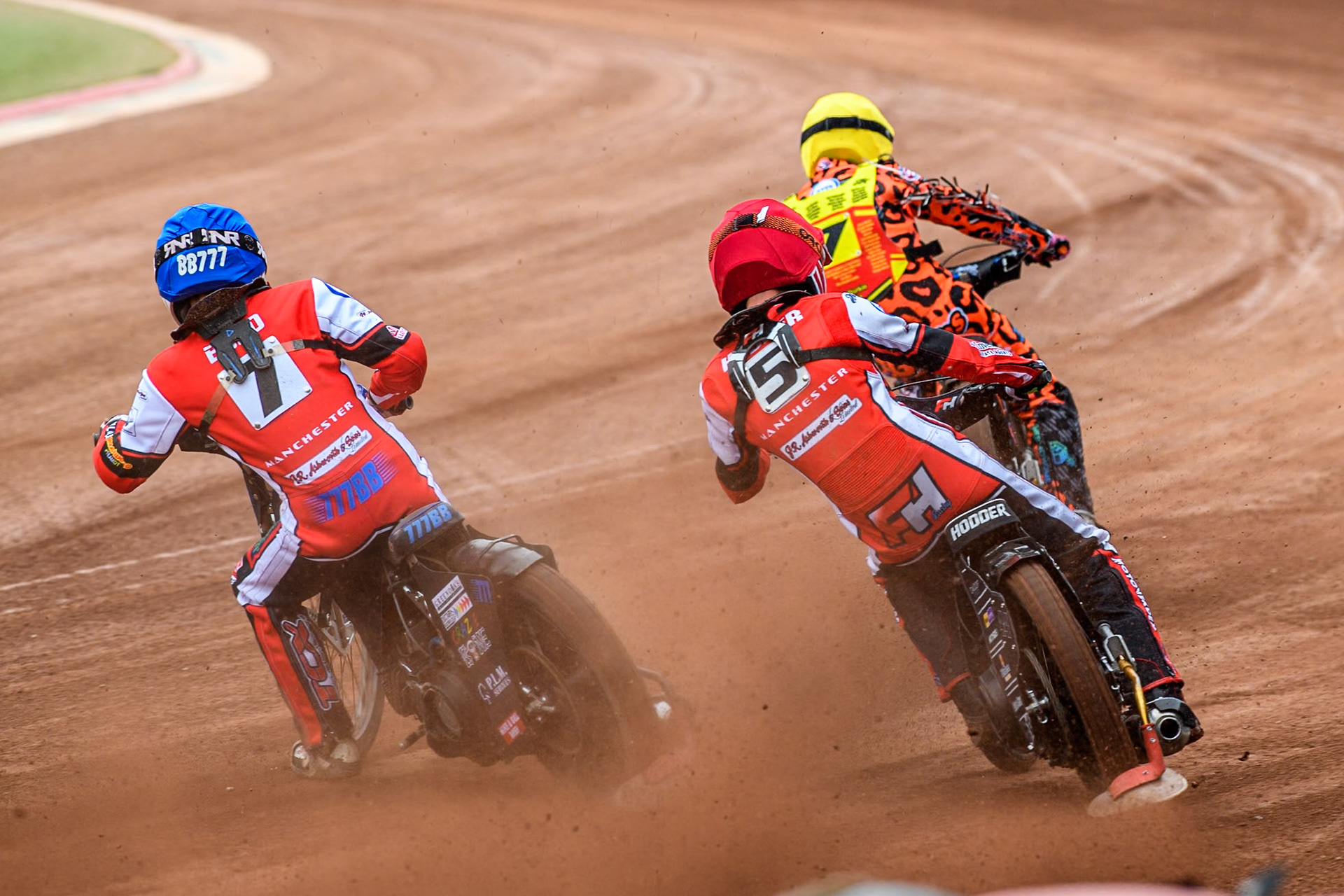 Belle Vue Colts' Freddy Hodder in Red chases Belle Vue Colts' Billy Budd in Blue and Leicester Lion Cubs' Cooper Rushen in Yellow during the WSRA National Development League match between Belle Vue Colts and Leicester Lion Cubs at the National Speedway Stadium, Manchester on Friday 18th April 2025. (Photo: Ian Charles | MI News)