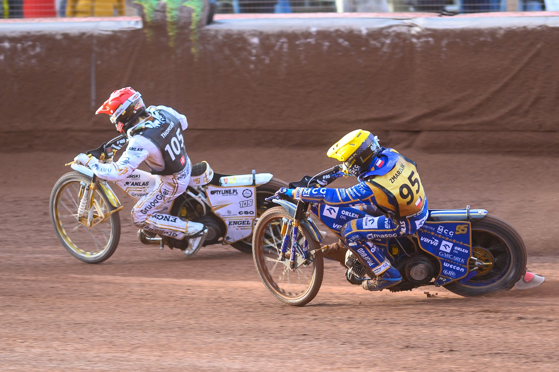 Bartosz Zmarzlik (95) of Poland in Yellow chases Anders Thomsen (105) of Denmark in Red during the ATPI  FIM Speedway GP of Manchester at the National Speedway Stadium, Manchester on Friday 5th June 2026. (Photo: Ian Charles | MI News)