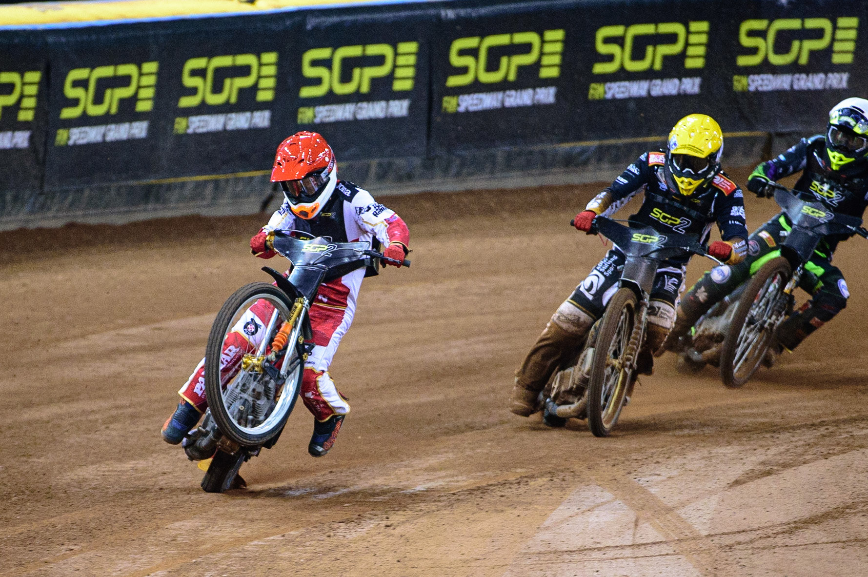 Mateusz Cierniak (Poland)  (Red) picks up some drive coming out of the 2nd turn ahead of Norick Blodorn (Germany)  (Yellow) and Tom Brennan (Great Britain)  (White) during the FIM  Speedway Grand Prix  2 of Great Britain at the Principality Stadium, Cardiff on Sunday 14th August 2022. (Credit: Ian Charles | MI News)
