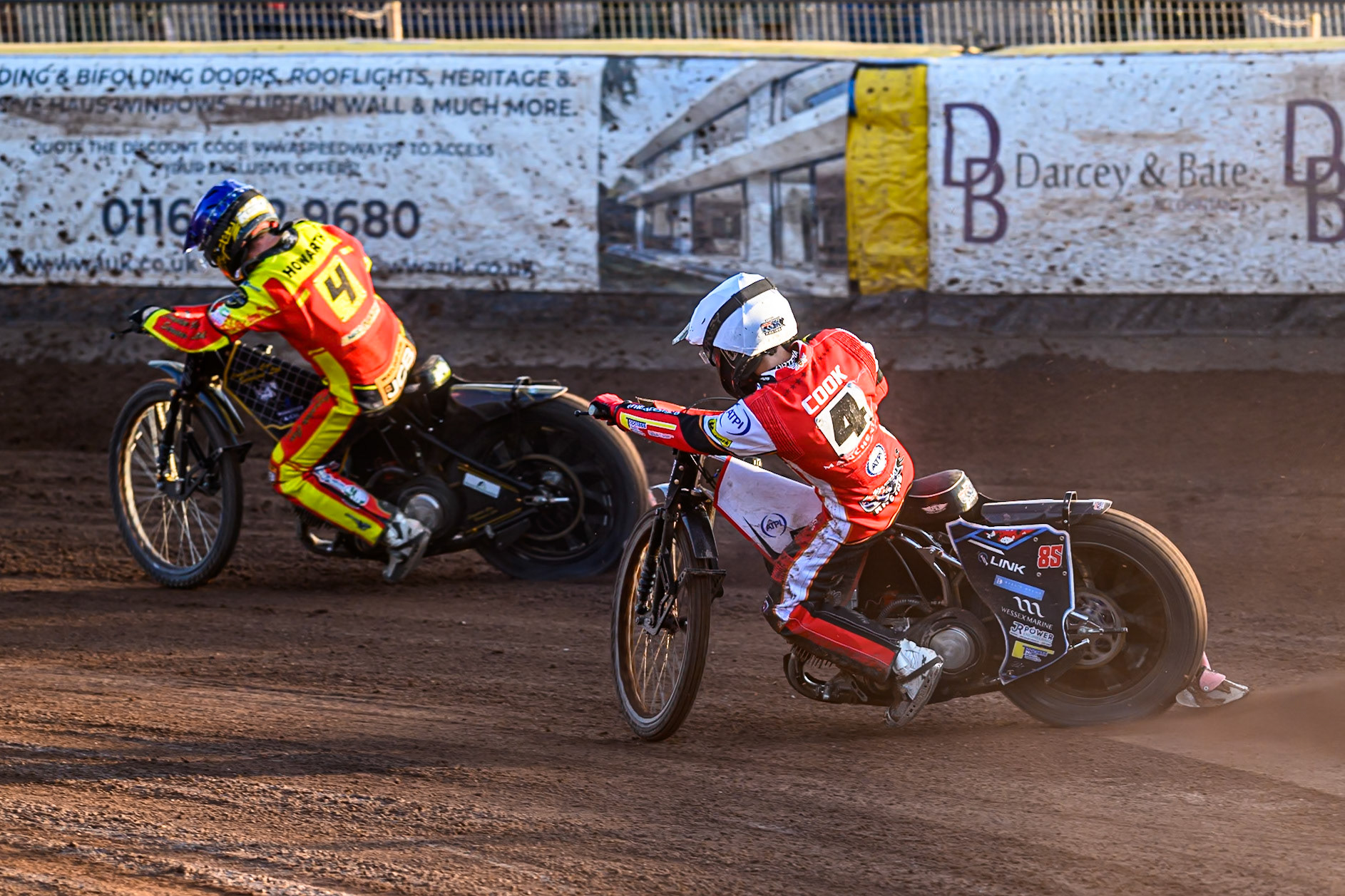 Belle Vue Aces' Zach Cook in White chases Leicester Lions' Kyle Howarth in Blue during the Rowe Motor Oil Premiership match between Leicester Lions and Belle Vue Aces at the Hydroscand Arena, Leicester on Thursday 19th June 2025. (Photo: Ian Charles | MI News)