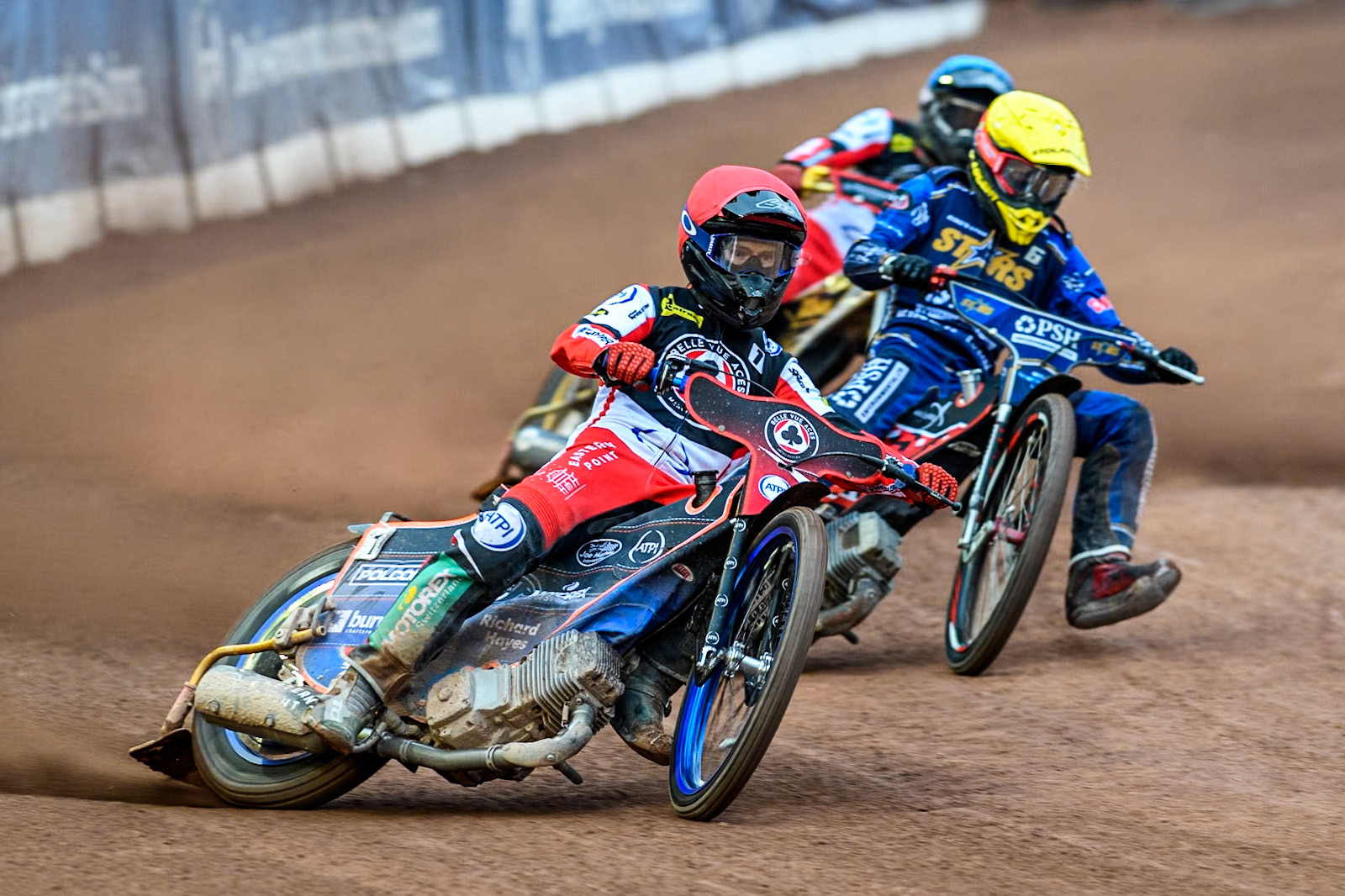 Belle Vue Aces' Brady Kurtz in Red leading King Lynn Stars' Patryk Wojdylo in Yellow and Belle Vue Aces' Norick Blodorn in Blue during the Rowe Motor Oil Premiership match between Belle Vue Aces and King's Lynn Stars at the National Speedway Stadium, Manchester on Monday 20th May 2024. (Photo: Ian Charles | MI News)