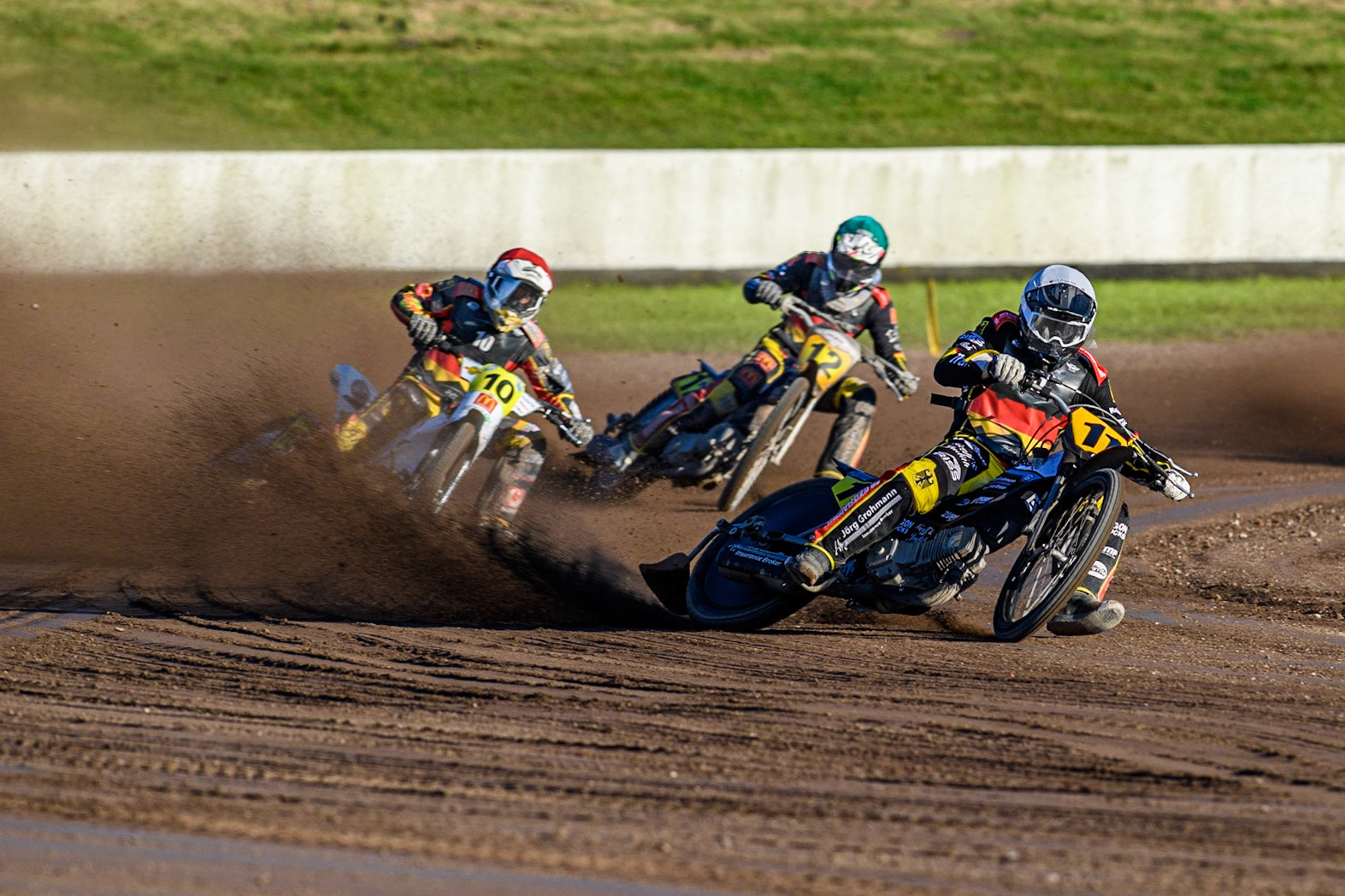 Germans Erik Riss (White), Martin Smolinski (Red) and Jörg Tebbe (Green) on their way to maximum points in Heat 13 during the FIM Long Track Of Nations event at the Speed Centre Roden on Sunday 24th September 2023. (Photo: Ian Charles | MI News)