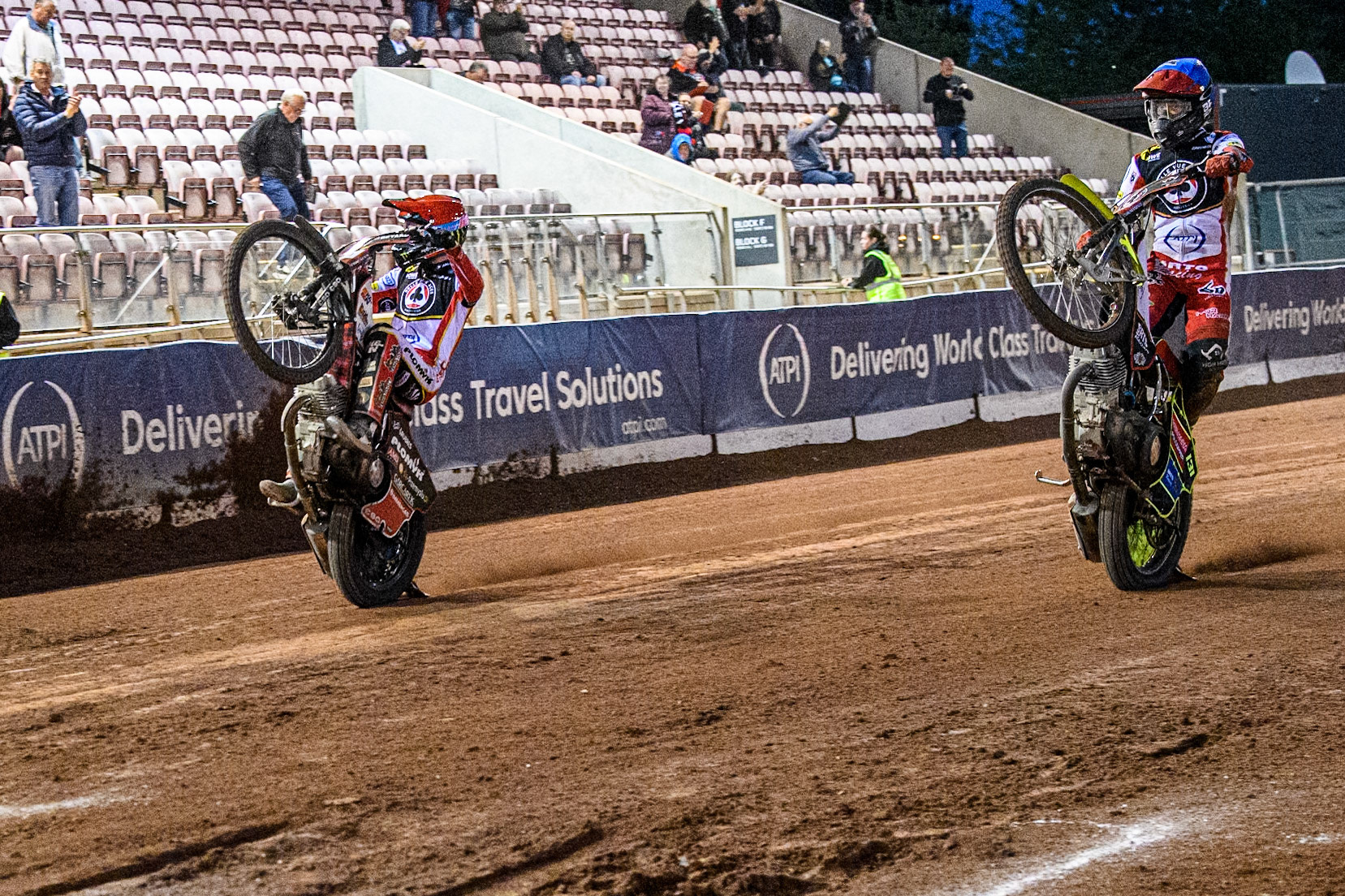 Belle Vue Aces' Dan Bewley (Left) and Belle Vue Aces' Tate Zischke celebrate with wheelies during the Rowe Motor Oil Premiership match between Belle Vue Aces and Leicester Lions at the National Speedway Stadium, Manchester on Monday 19th May 2025. (Photo: Ian Charles | MI News)