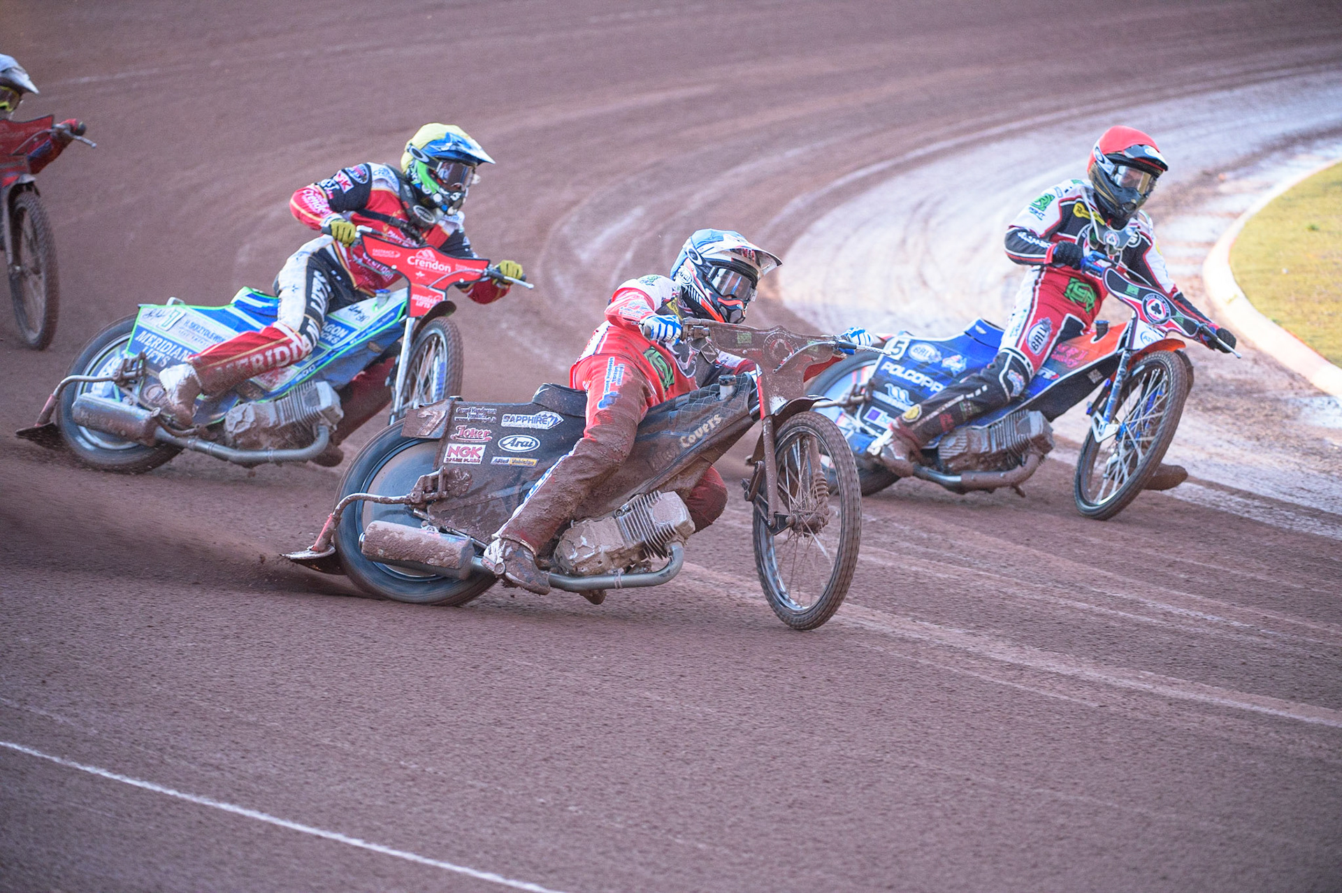 MANCHESTER, UK. AUG 9TH  Ricky Wells (Blue) outside Brady Kurtz  (Red) as they lead Hans Andersen (Yellow)  during the SGB Premiership match between Belle Vue Aces and Peterborough at the National Speedway Stadium, Manchester on Monday 9th August 2021. (Credit: Ian Charles | MI News)