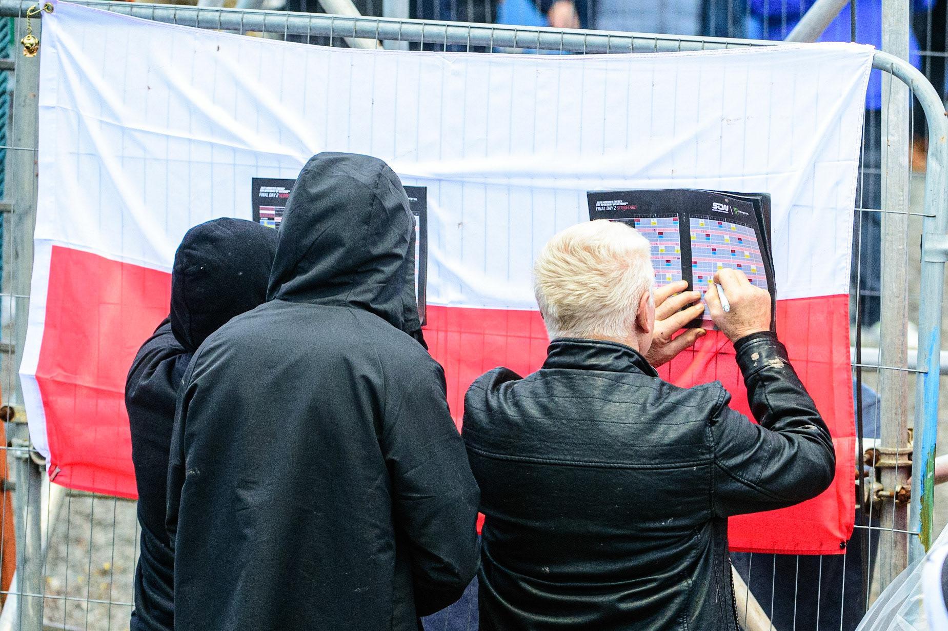 MANCHESTER, UK. OCT 17TH Polish fans mark their programmes during the Monster Energy FIM Speedway of Nations at the National Speedway Stadium, Manchester on Sunday  17th October 2021. (Credit: Ian Charles | MI News)