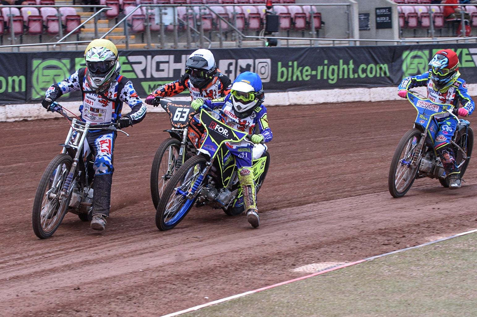 MANCHESTER, UK. AUGUST 2OTH   Billy Budd (Yellow) leads as Cooper Rushen  (White) and Oliver Bovingdon  (Blue) get close to each other with Rico Joyce  (Red) behindat the National Speedway Stadium, Manchester on Friday 20th August 2021. (Credit: Ian Charles | MI News)