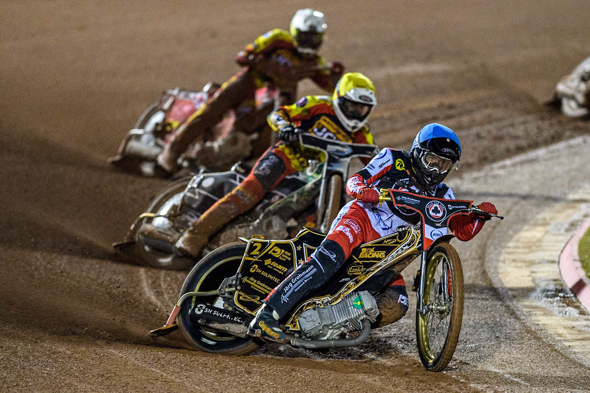 Belle Vue Aces' Norick Blodorn  in Blue leading Leicester Lions' Richard Lawson  in Yellow and Leicester Lions' Max Fricke  in White during the Rowe Motor Oil Premiership Grand Final 1st Leg between Belle Vue Aces and Leicester Lions at the National Speedway Stadium, Manchester on Monday 23rd September 2024. (Photo: Ian Charles | MI News)