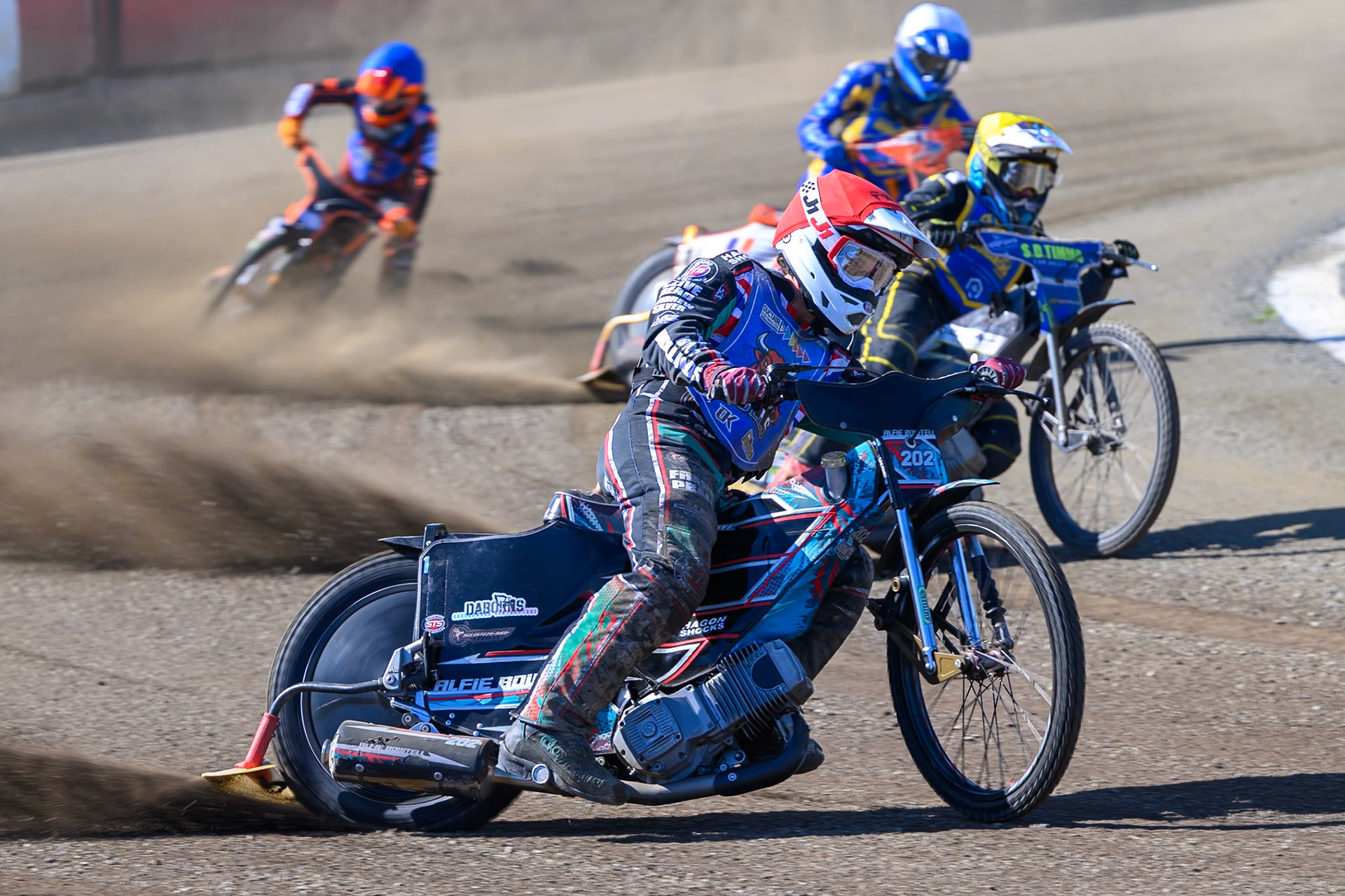 Alfie Bowtell of Buxton Bulls in Red leading Dayle Wood of Edinburgh Monarchs Academy in Yellow, Jordy Loftus of Edinburgh Monarchs Academy in White and Jack Smith of Buxton Bulls in Blue during the WSRA National Development League match between Buxton Bulls and Edinburgh Monarchs Academy at Hi-Edge Speedway, Buxton on Sunday 14th June 2026. (Photo: Ian Charles | MI News)