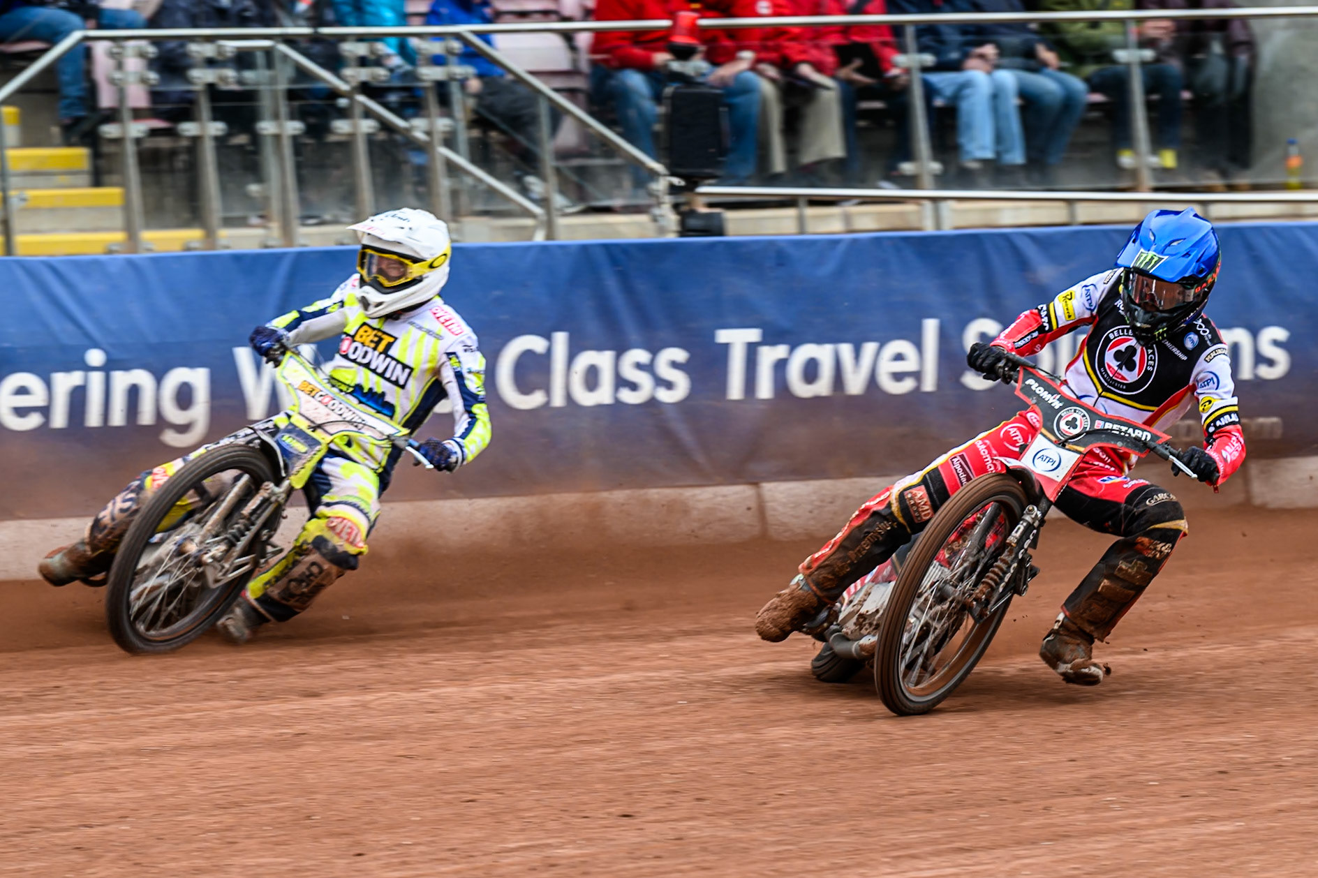 Belle Vue Aces' Dan Bewley in Blue rides inside Oxford Spires' Peter Kildemand in White during the Rowe Motor Oil Premiership match between Belle Vue Aces and Oxford Spires at the National Speedway Stadium, Manchester on Monday 26th May 2025. (Photo: Ian Charles | MI News)