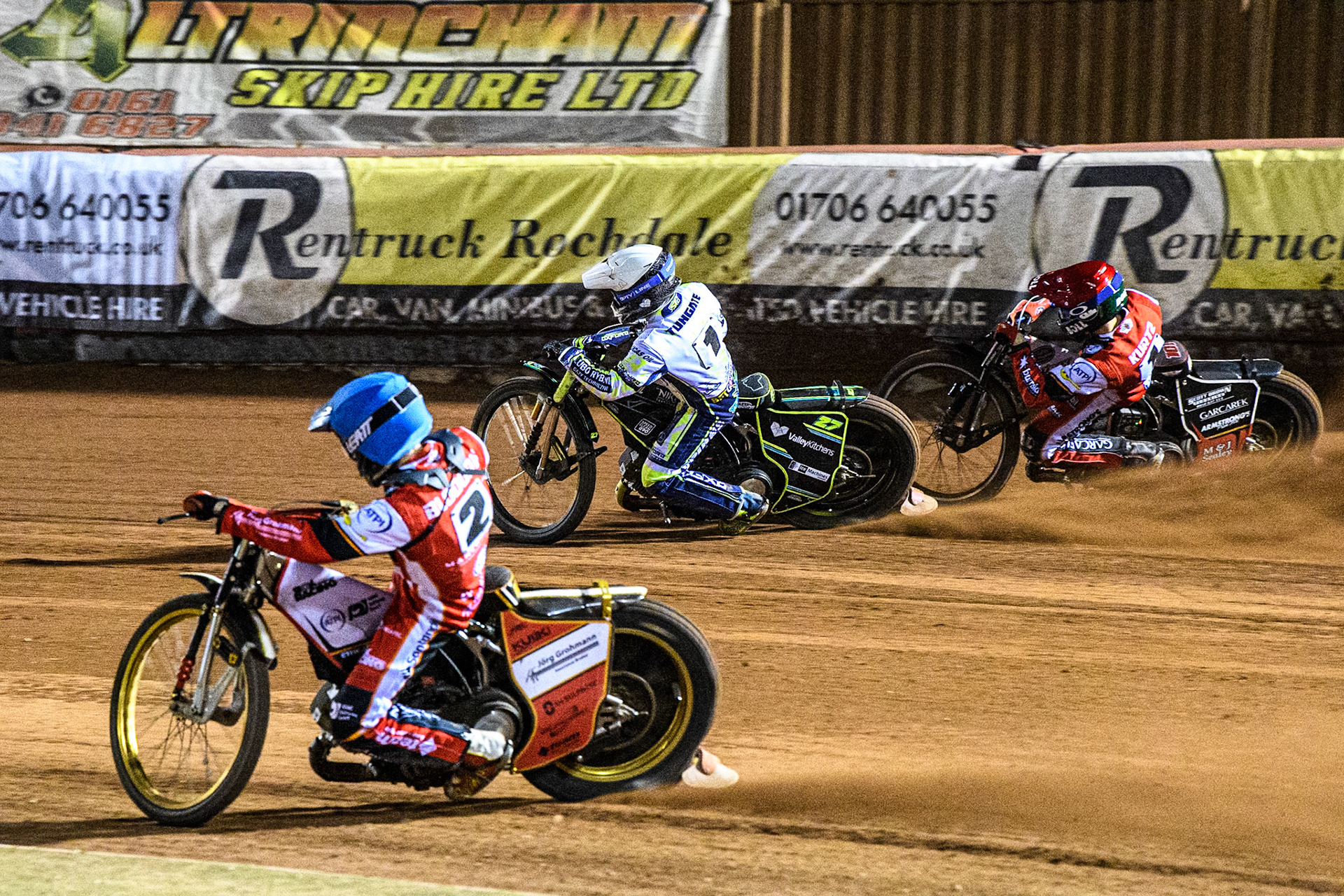 Belle Vue Aces' Norick Blodorn in Blue rides inside Oxford Spires' Rohan Tungate in White and Belle Vue Aces' Brady Kurtz in Red during the Rowe Motor Oil Premiership match between Belle Vue Aces and Oxford Spires at the National Speedway Stadium, Manchester on Monday 14th April 2025. (Photo: Ian Charles | MI News)