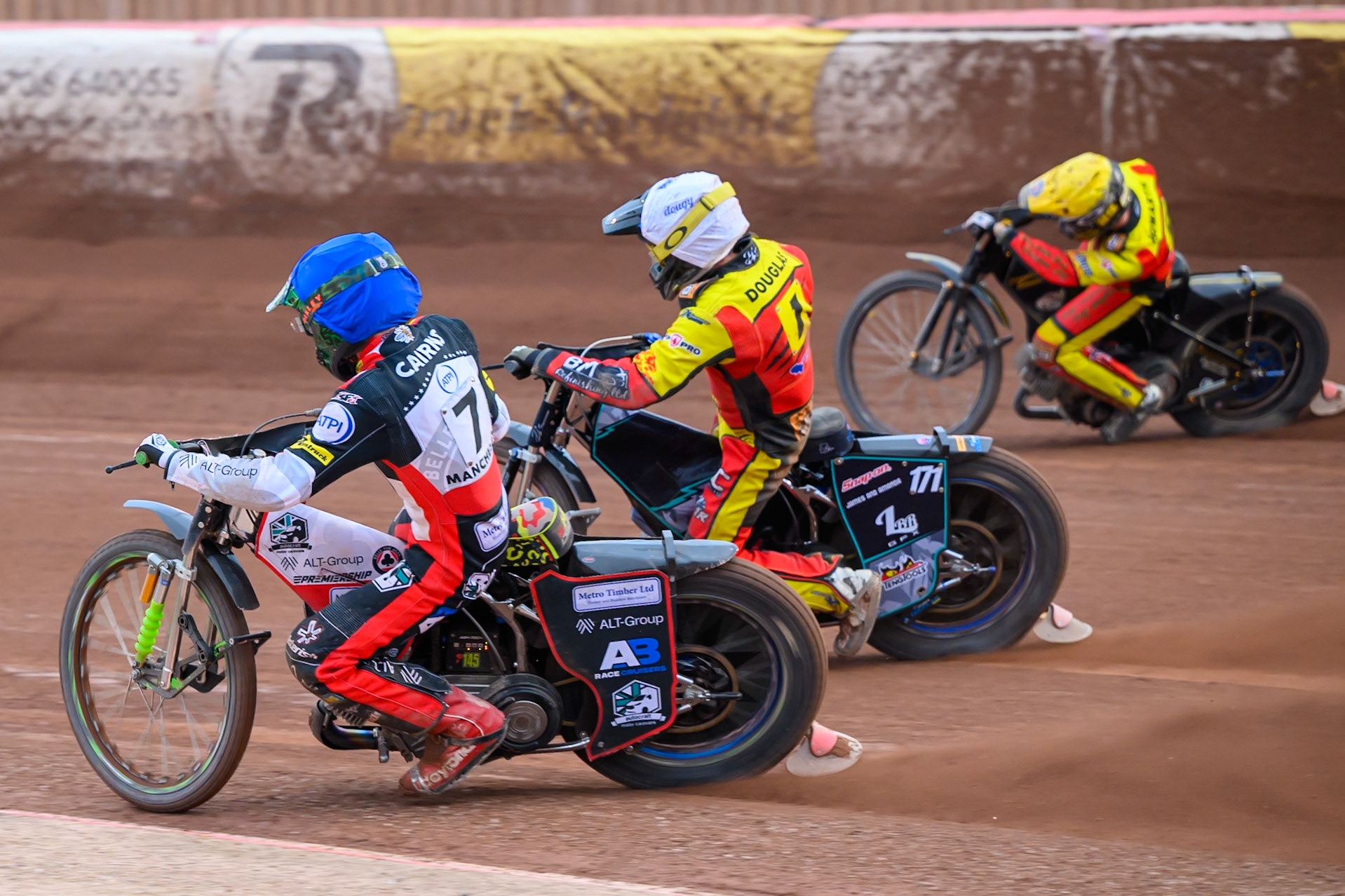 William Cairns of Belle Vue Aces in Blue rides inside Ryan Douglas of Leicester Lions in White and Kyle Howarth of Leicester Lions in Yellow during the Rowe Motor Oil Premiership match between Belle Vue Aces and Leicester Lions at the National Speedway Stadium, Manchester on Monday 15th June 2026. (Photo: Ian Charles | MI News)