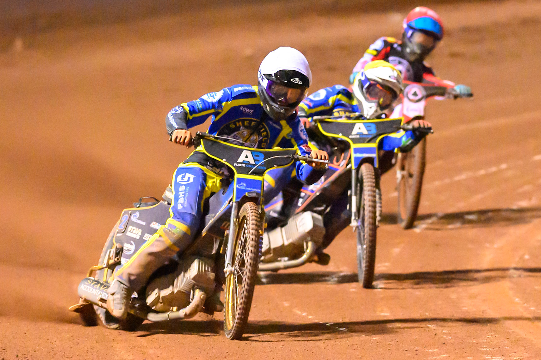 Anders Rowe of Sheffield Tigers    in White and Luke Killeen of Sheffield Tigers in Yellow leading Tate Zischke of Belle Vue Aces   in Red during the Knockout Cup, Northern Section match between Belle Vue Aces and Sheffield Tigers at the National Speedway Stadium, Manchester on Monday 30th March 2026. (Photo: Ian Charles | MI News)