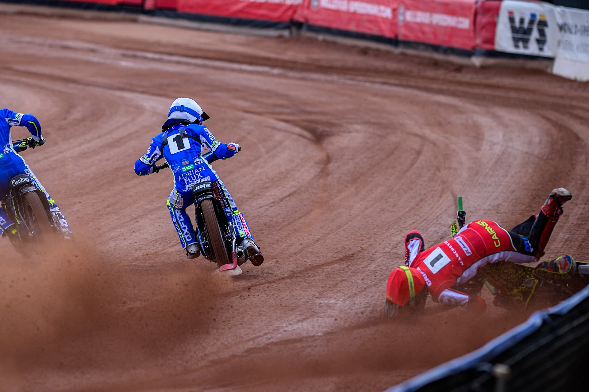 Belle Vue Colts' William Cairns falls whilst trying to pass Oxford Chargers' Jody Scott  in White and Oxford Chargers' Jacob Clouting  in Yellow during the WSRA National Development League match between Belle Vue Colts and Oxford Chargers at the National Speedway Stadium, Manchester on Sunday 1st June 2025. (Photo: Ian Charles | MI News)