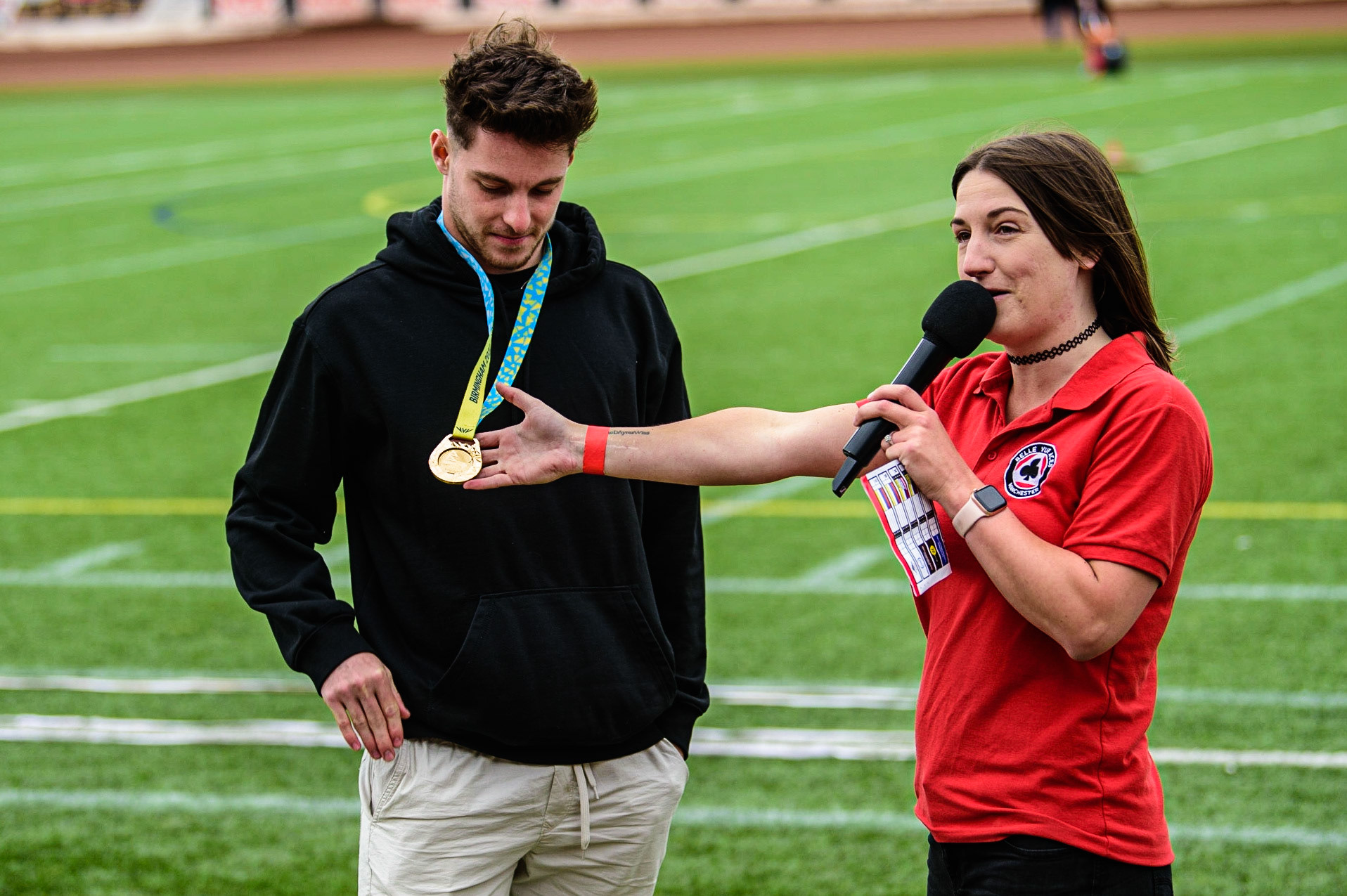 Meeting presenter Hayley Bromley (right) introduces Commonwealth Gold Synchro Divining Gold Medal winner Anthony Harding to the fans.Harding is a Belle Vue Aces supporter, who attends when his training permits,  during the SGB Premiership match between Belle Vue Aces and Wolverhampton Wolves at the National Speedway Stadium, Manchester on Monday 29th August 2022. (Credit: Ian Charles | MI News)