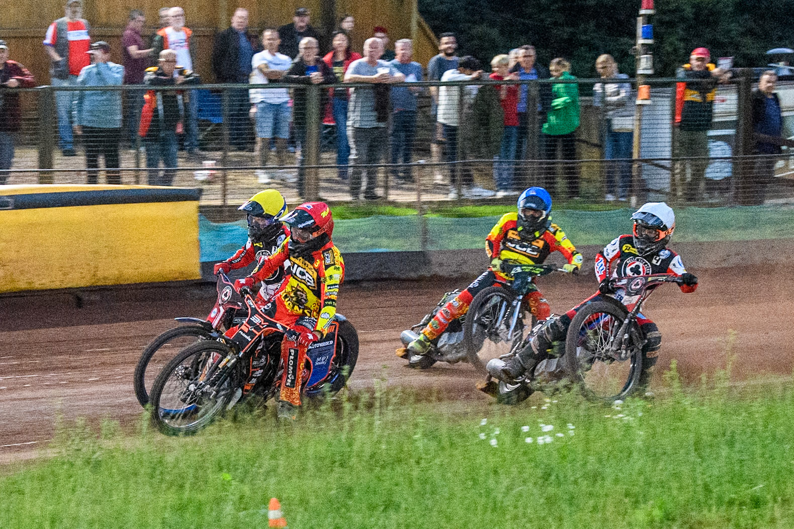 Leicester Lions' Sam Masters in Red rides inside Belle Vue Aces' Brady Kurtz in Yellow with Belle Vue Aces' Ben Cook in White and Leicester Lions' Craig Cook in Yellow behind during the Rowe Motor Oil Premiership match between Leicester Lions and Belle Vue Aces at the Pidcock Motorcycles Arena, Leicester on Thursday 25th July 2024. (Photo: Ian Charles | MI News)