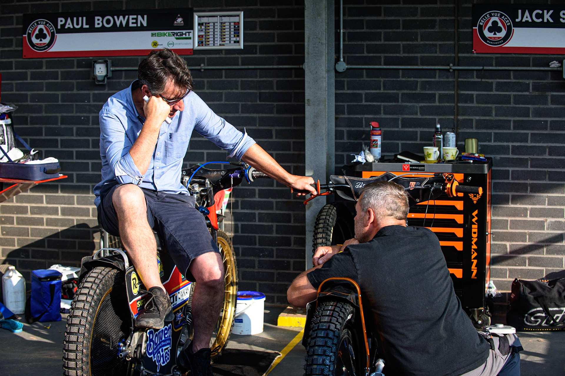 MANCHESTER, UK. JULY 23RD  Belle Vue director of Speedway Mark Lemon (left) chats with former Belle Vue rider Andy Smith, who was at the NSS with his son Jack during the National Development League match between Belle Vue Colts and Eastbourne Seagulls at the National Speedway Stadium, Manchester on Friday 23rd July 2021. (Credit: Ian Charles | MI News)