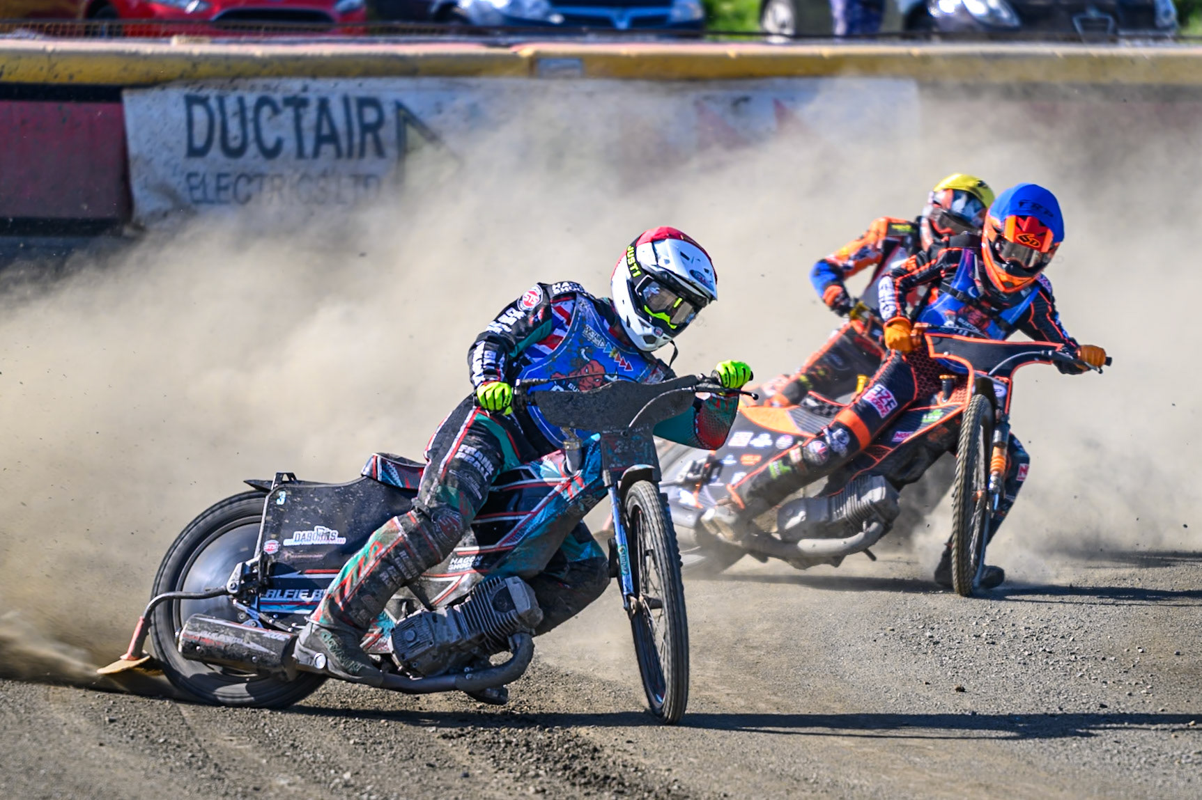 Alfie Bowtell of Buxton Bulls in Red leading Jack Smith of Buxton Bulls in Blue and Mickie Simpson of Stoke Potters in Yellow during the National Development League Challenge match between Buxton Bulls and Stoke Potters at Hi-Edge Speedway, Buxton on Sunday 24th May 2026. (Photo: Ian Charles | MI News)